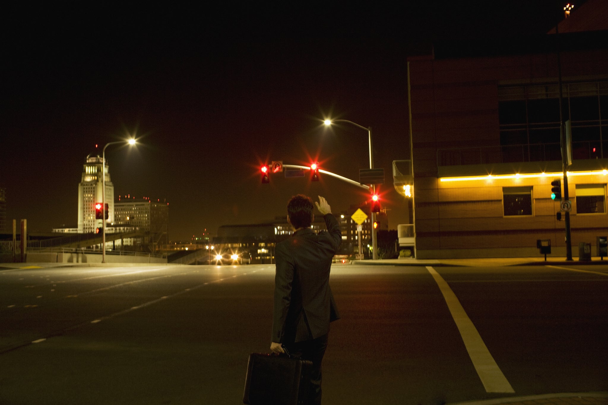 A businessman hails a taxi in Los Angeles