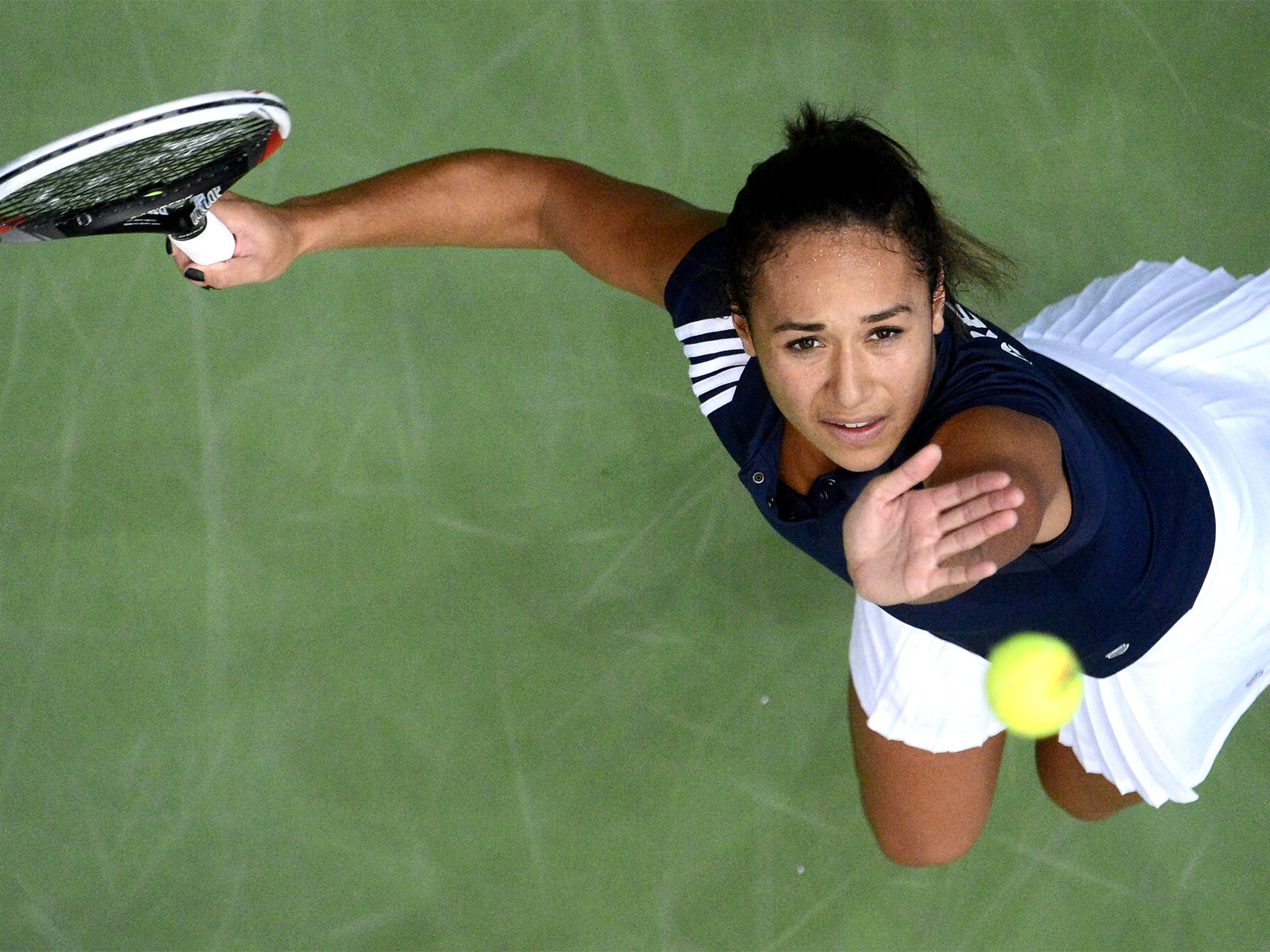 Heather Watson serves against Latvia’s Jelena Ostapenko