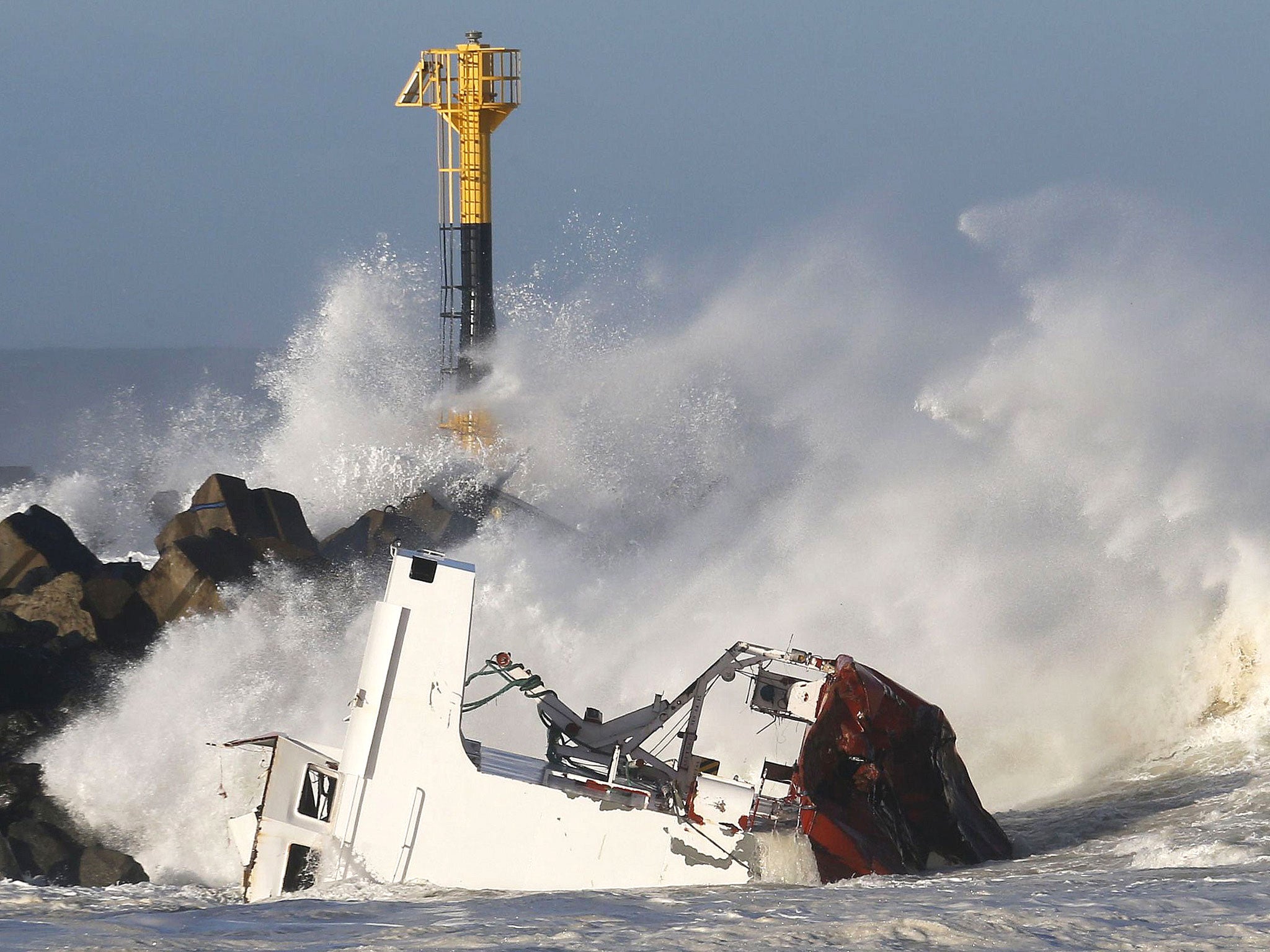 A Spanish cargo ship broke in two after hitting a sea wall off the southwestern coast of France in high winds and was leaking some fuel into the water