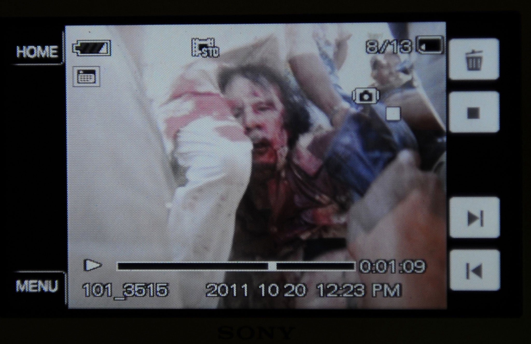 An image taken on a mobile phone of Muammar Gaddafi's capture in 2011