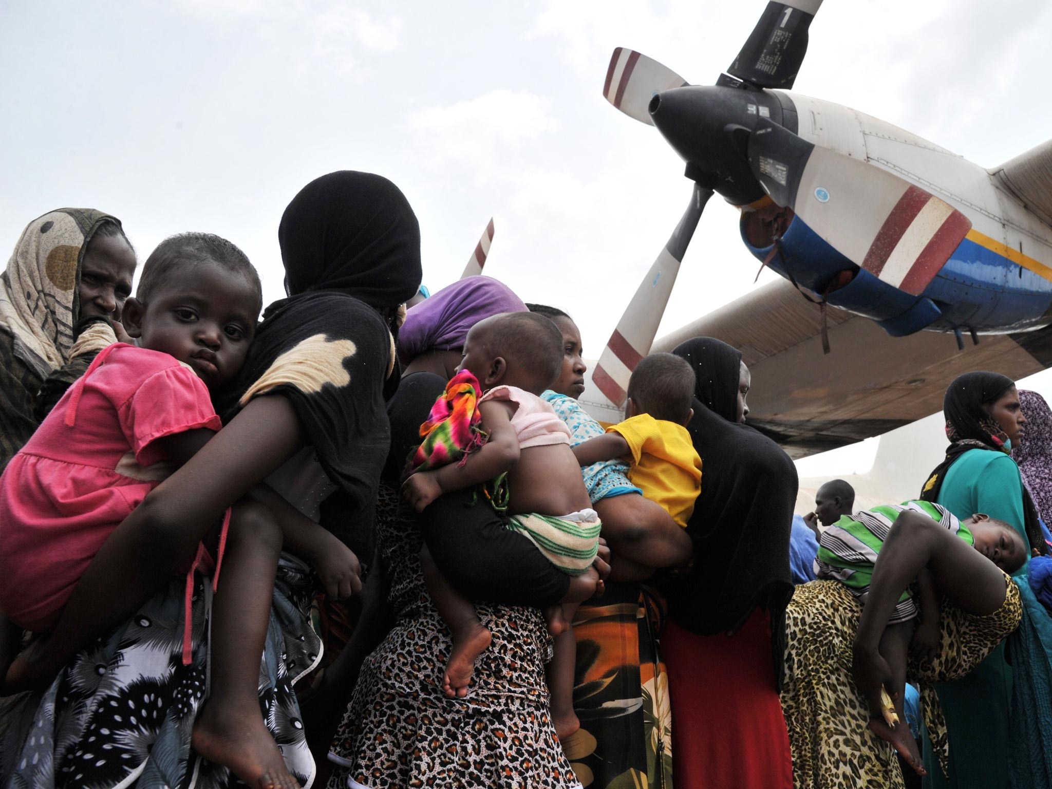 Chadian nationals and other Muslims queue at a Bangui military base for evacuation flights to Chad