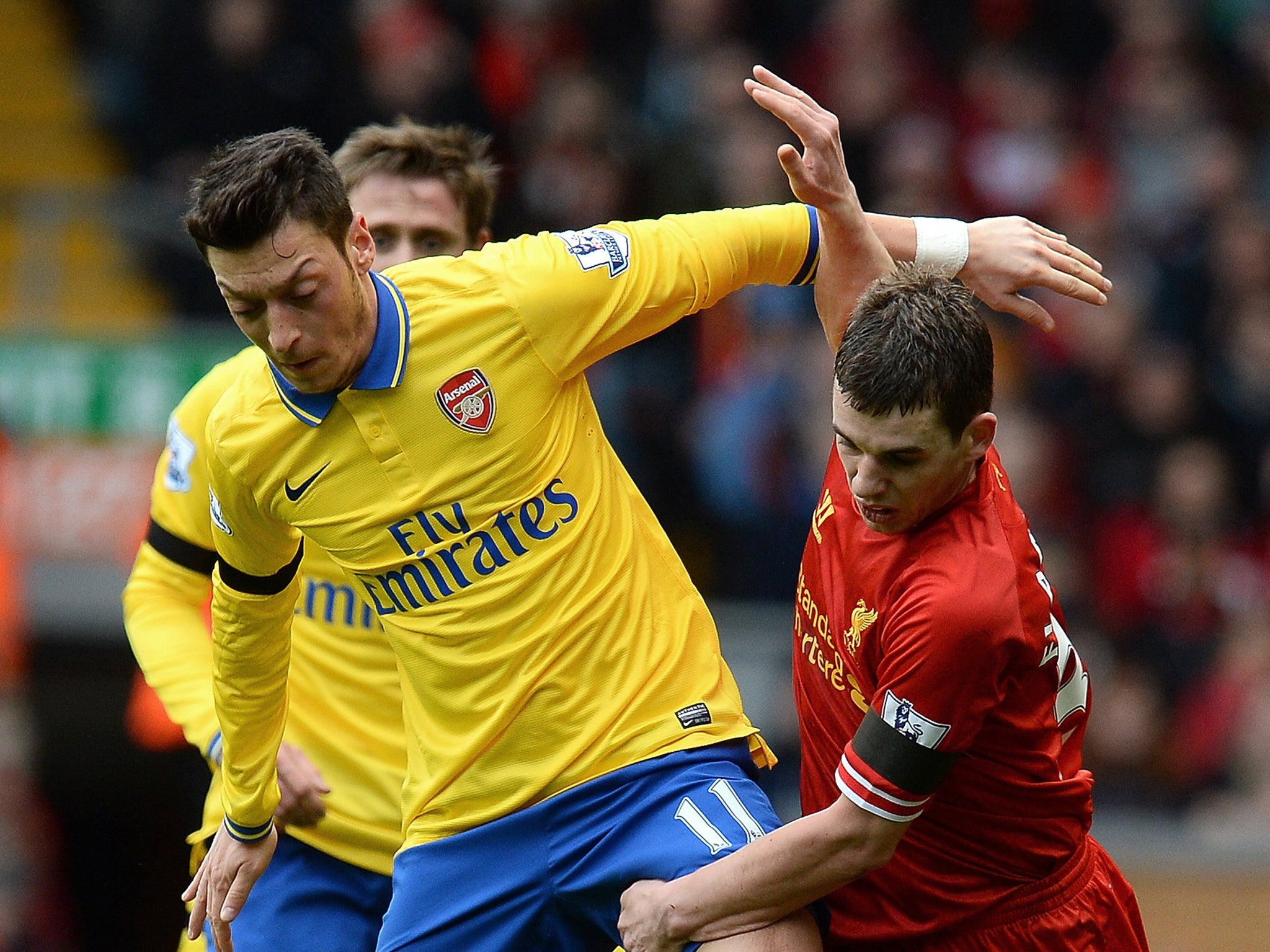 Mesut Ozil loses possession to Liverpool's Jon Flanagan