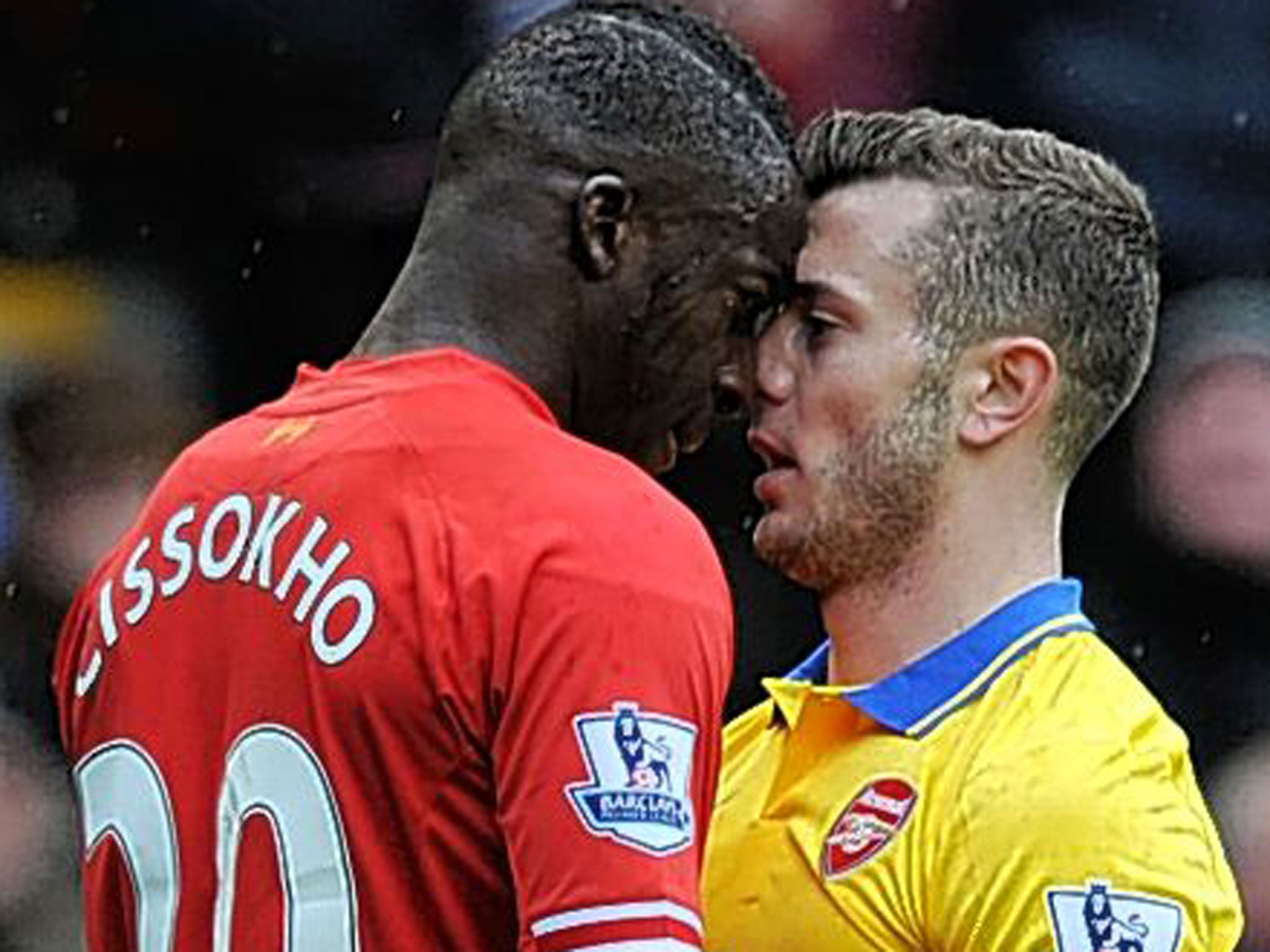 Liverpool's Aly Cissokho and Arsenal's Jack Wilshere square up