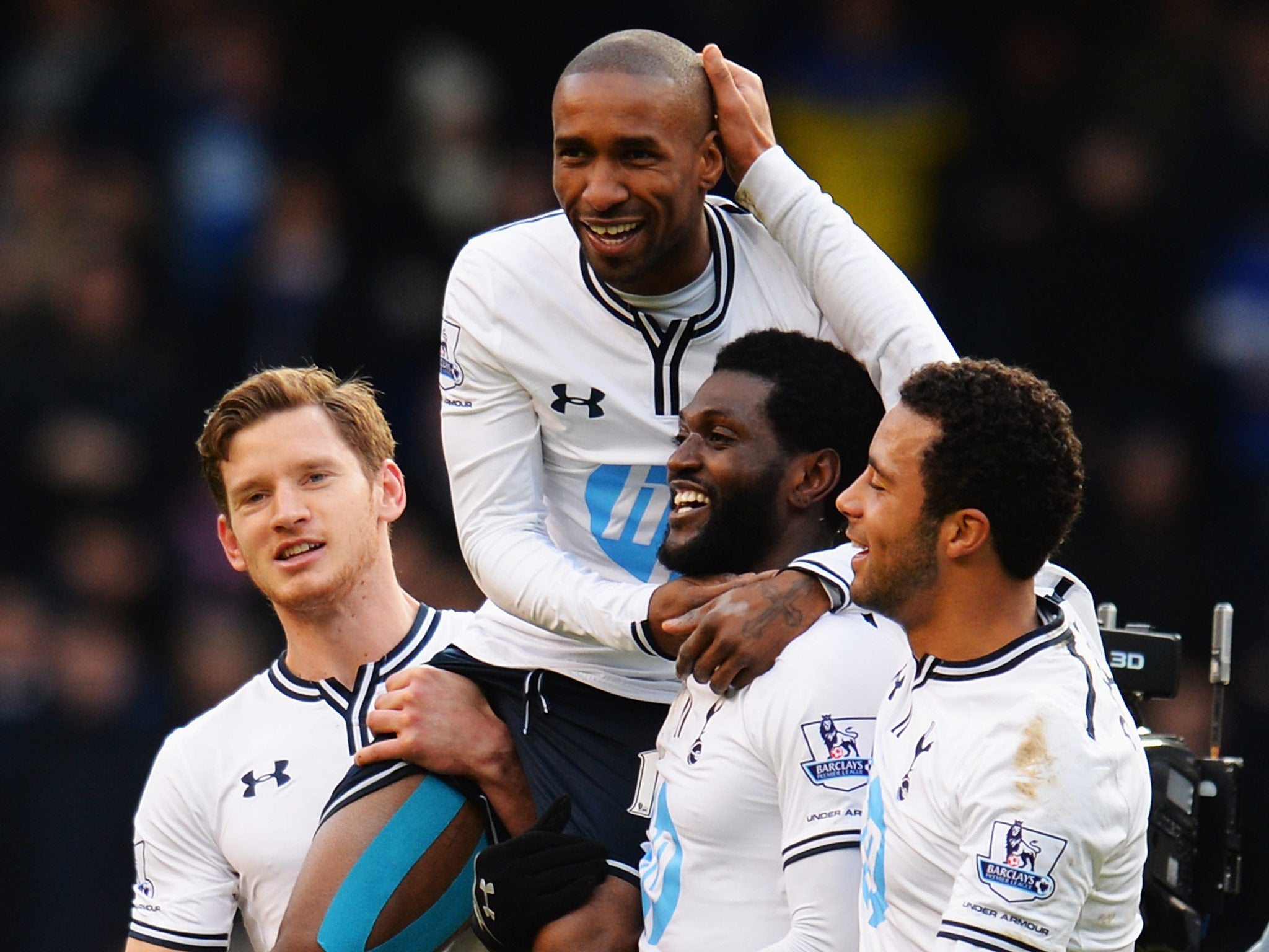 Jermain Defoe (C) of Tottenham Hotspur is carried on the shoulders of team mates Jan Vertonghen (L) and Emmanuel Adebayor (R) at the end of his final home game