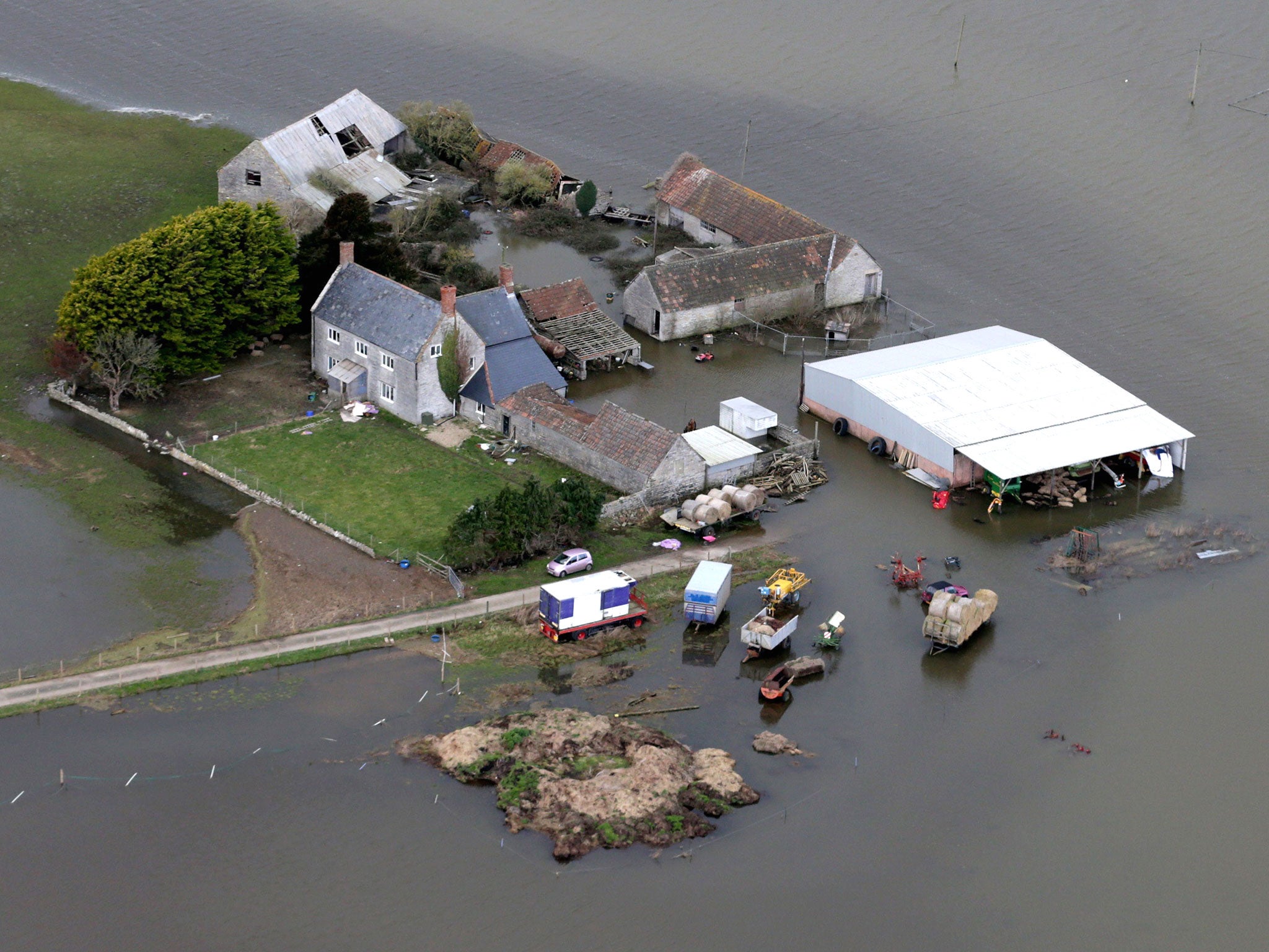 Flood water surrounds Horsey Farm close to the village of Muchelney on the Somerset Levels near Langport in Somerset