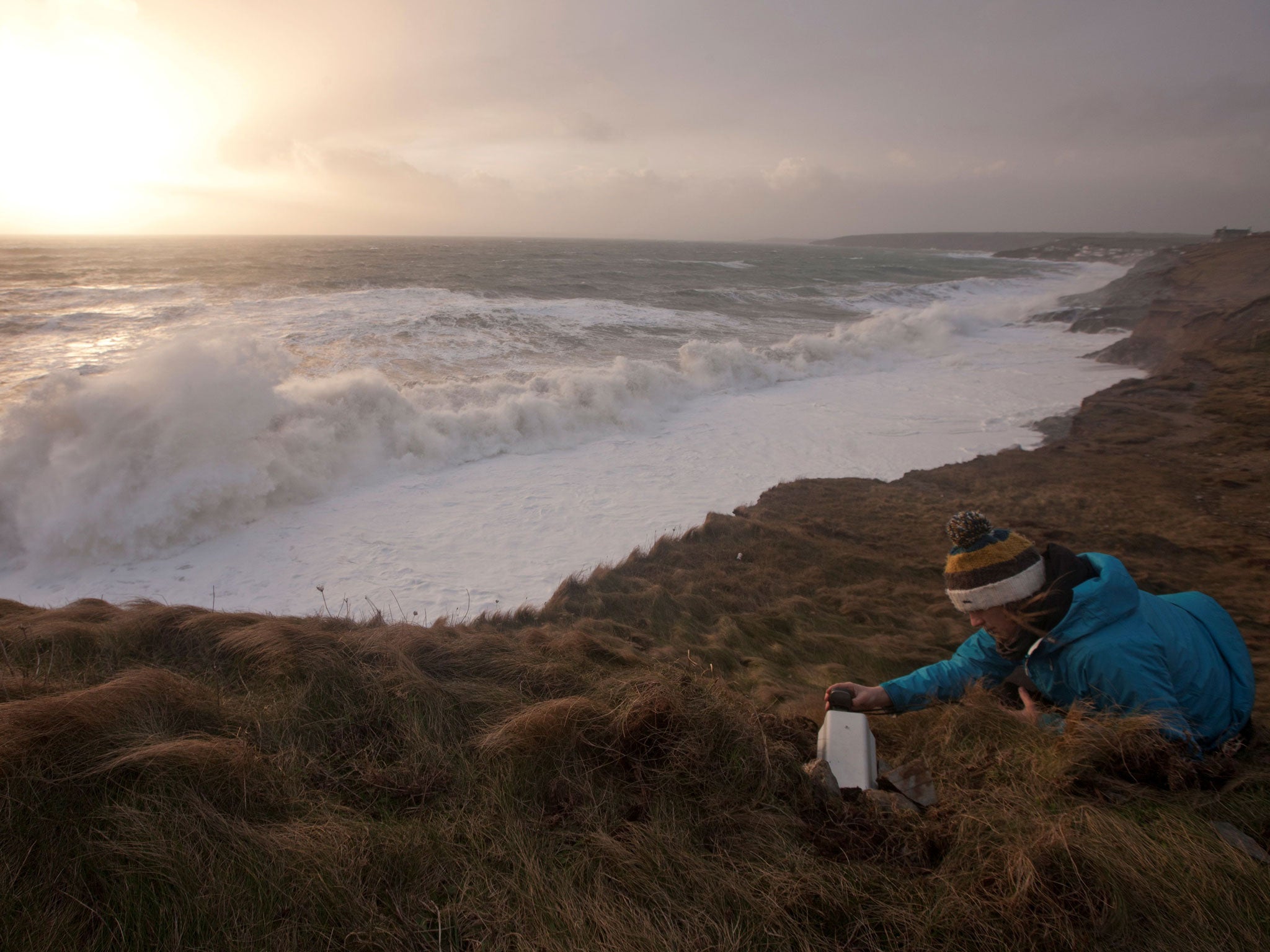 A member of the team uses a seismometers to measure the waves' height