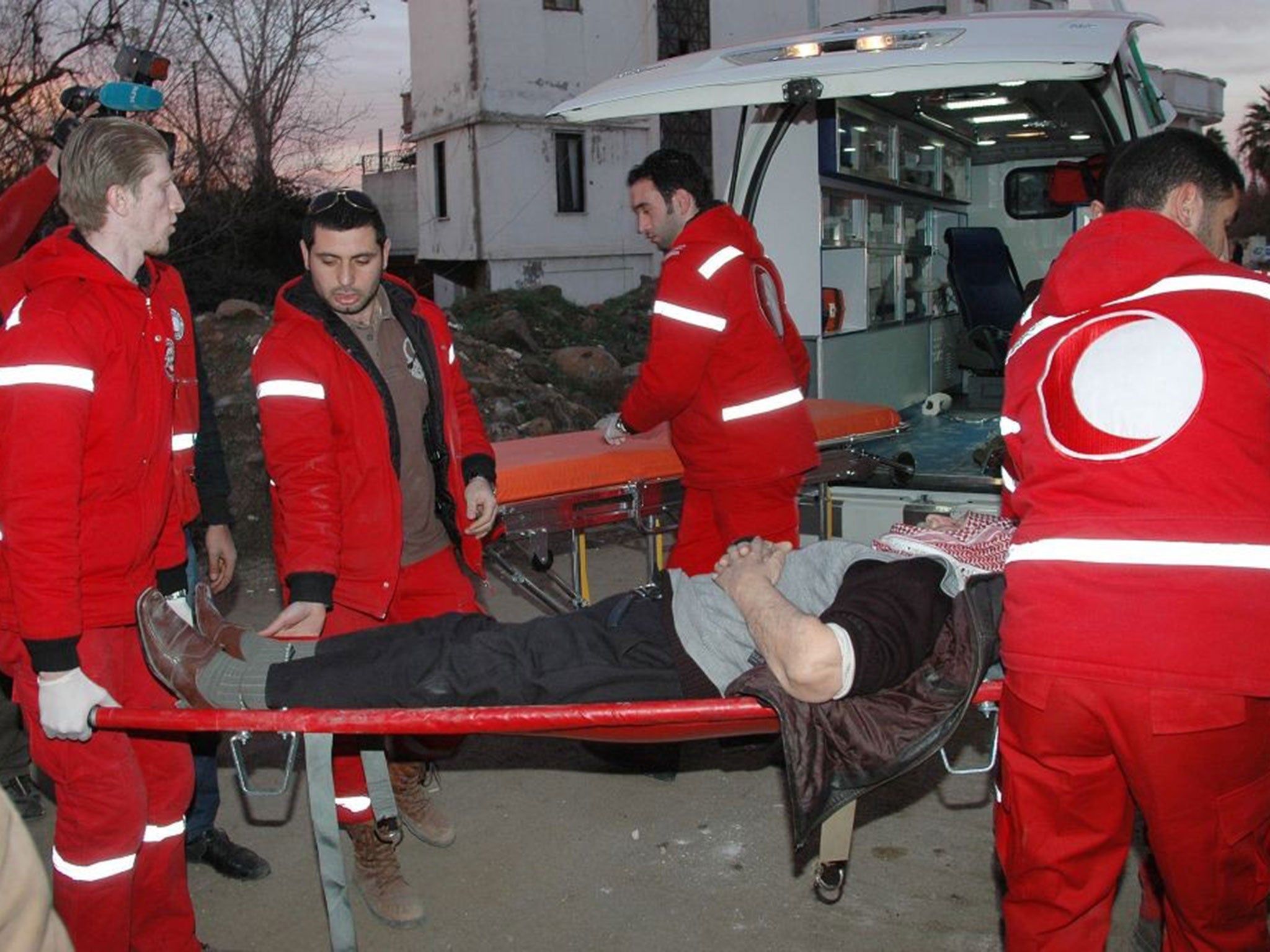 Syrian Red Cross workers work in a shelter in Homs during the ceasefire