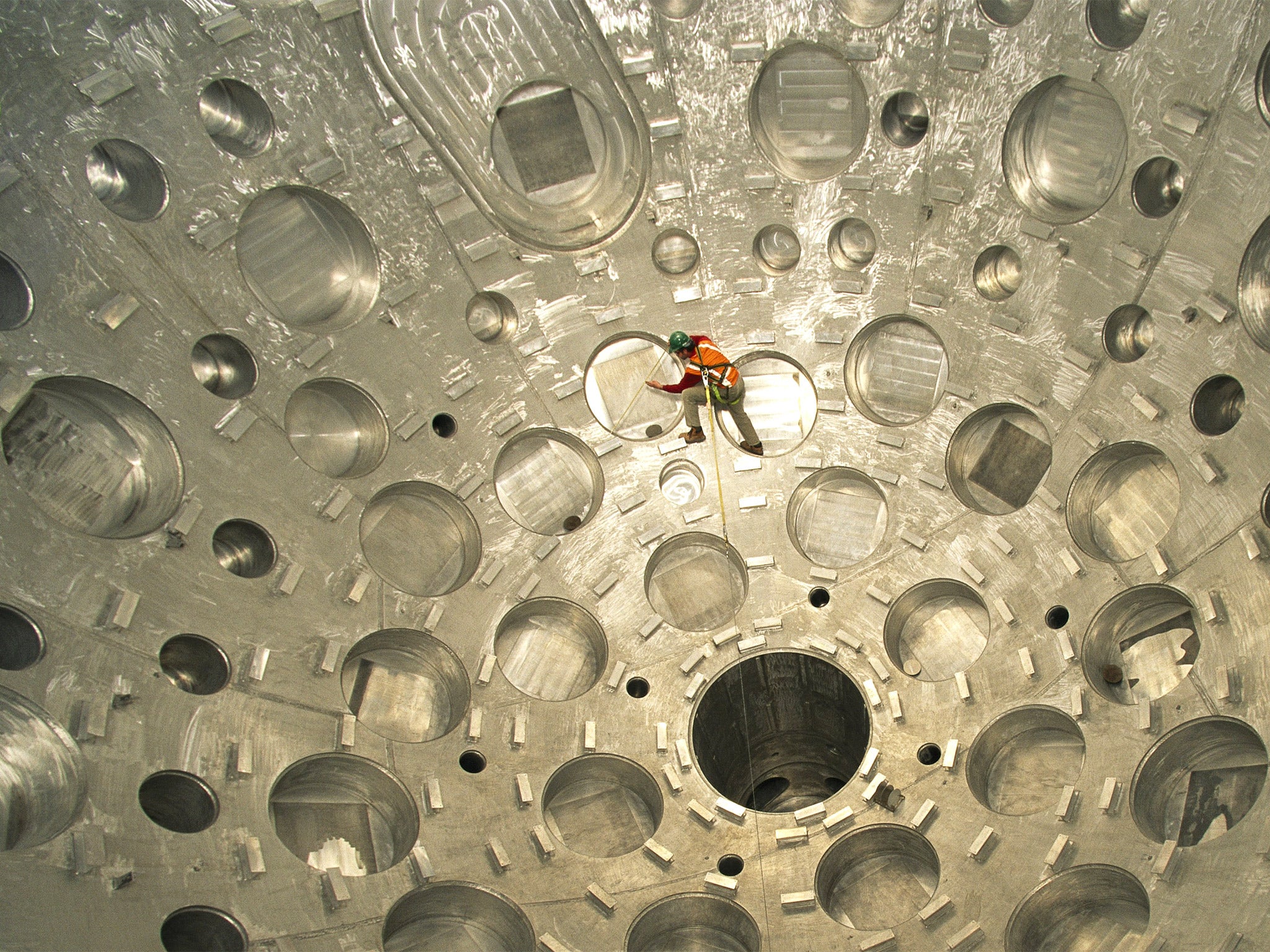 A worker inspects a target chamber at the National Ignition Facility in California