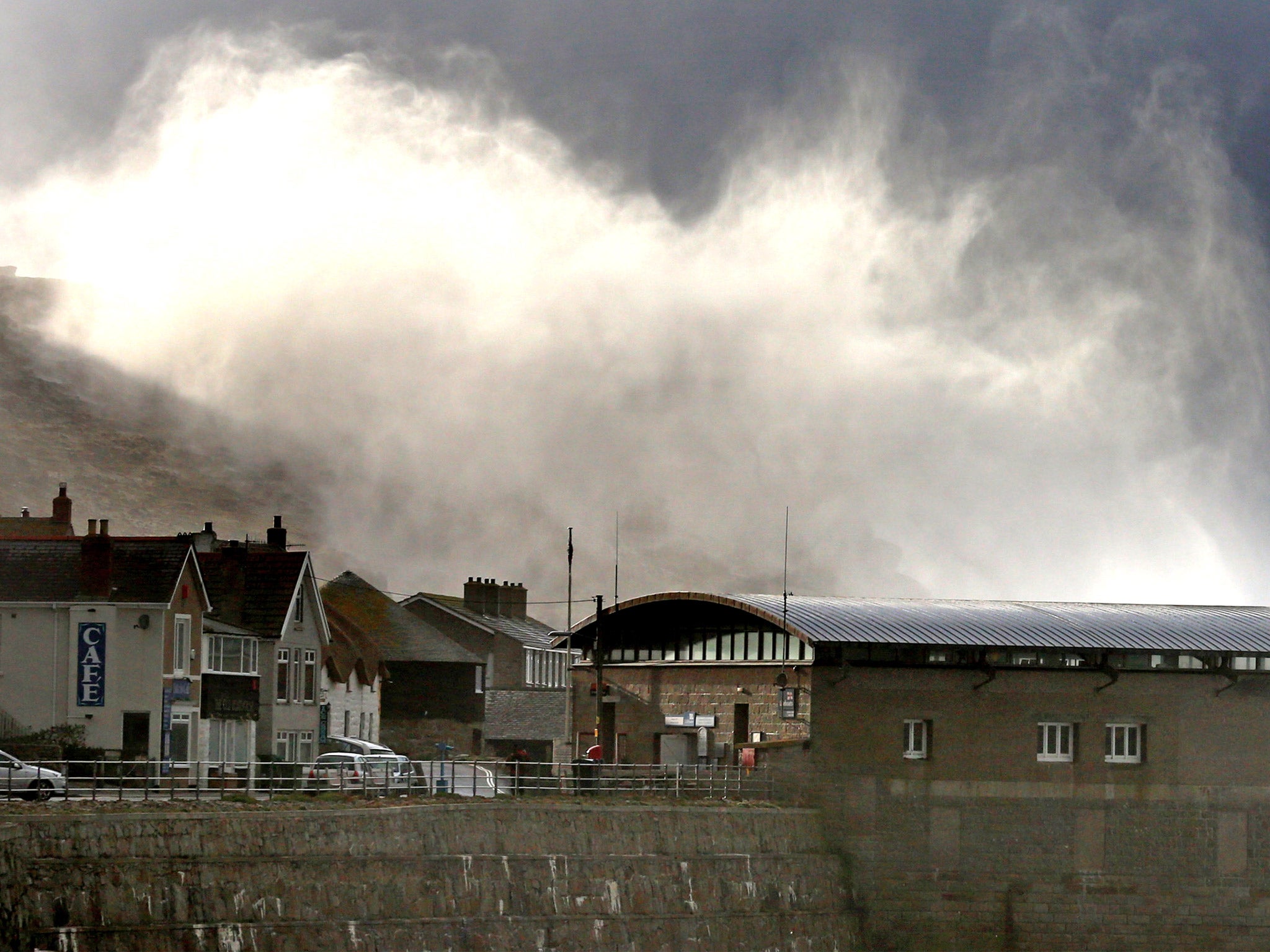 Storm waves crash over cliffs at Sennen Cove near Lands End
