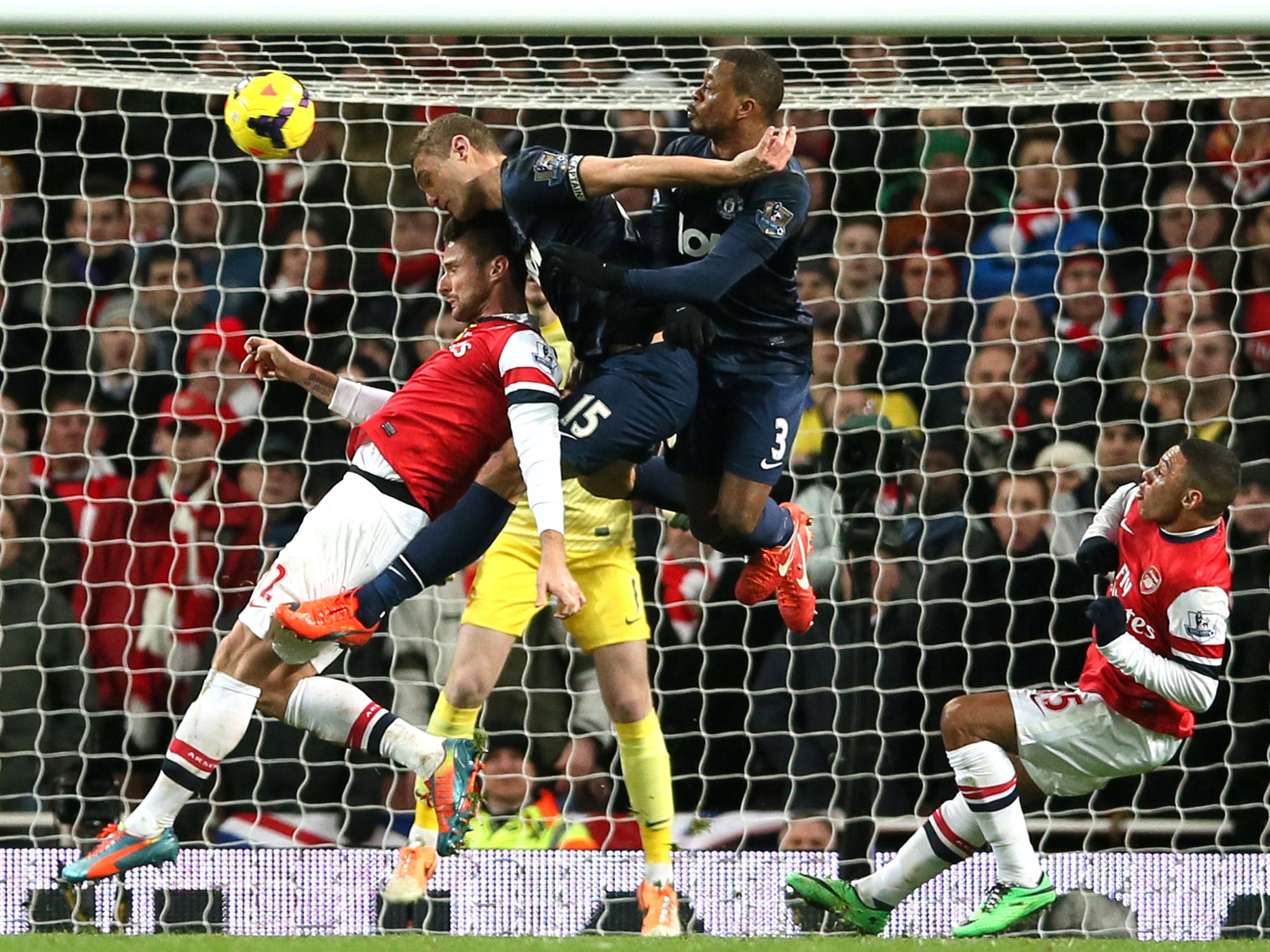 Nemanja Vidic and Patrice Evra combine to deny Oliver Giroud connecting to a cross