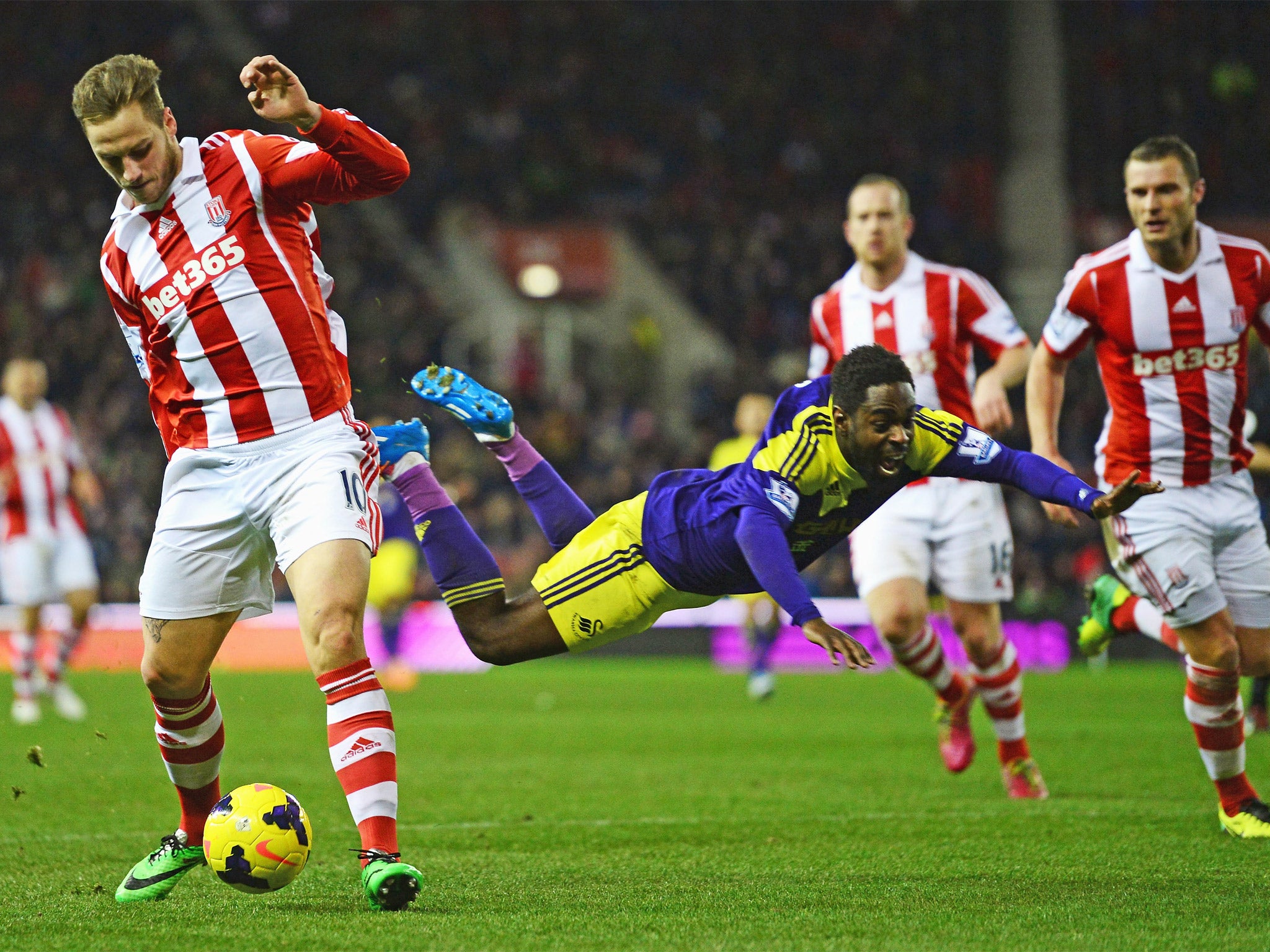 Swansea's Nathan Dyer falls spectacularly as Marko Arnautovic comes away with the ball (Getty)