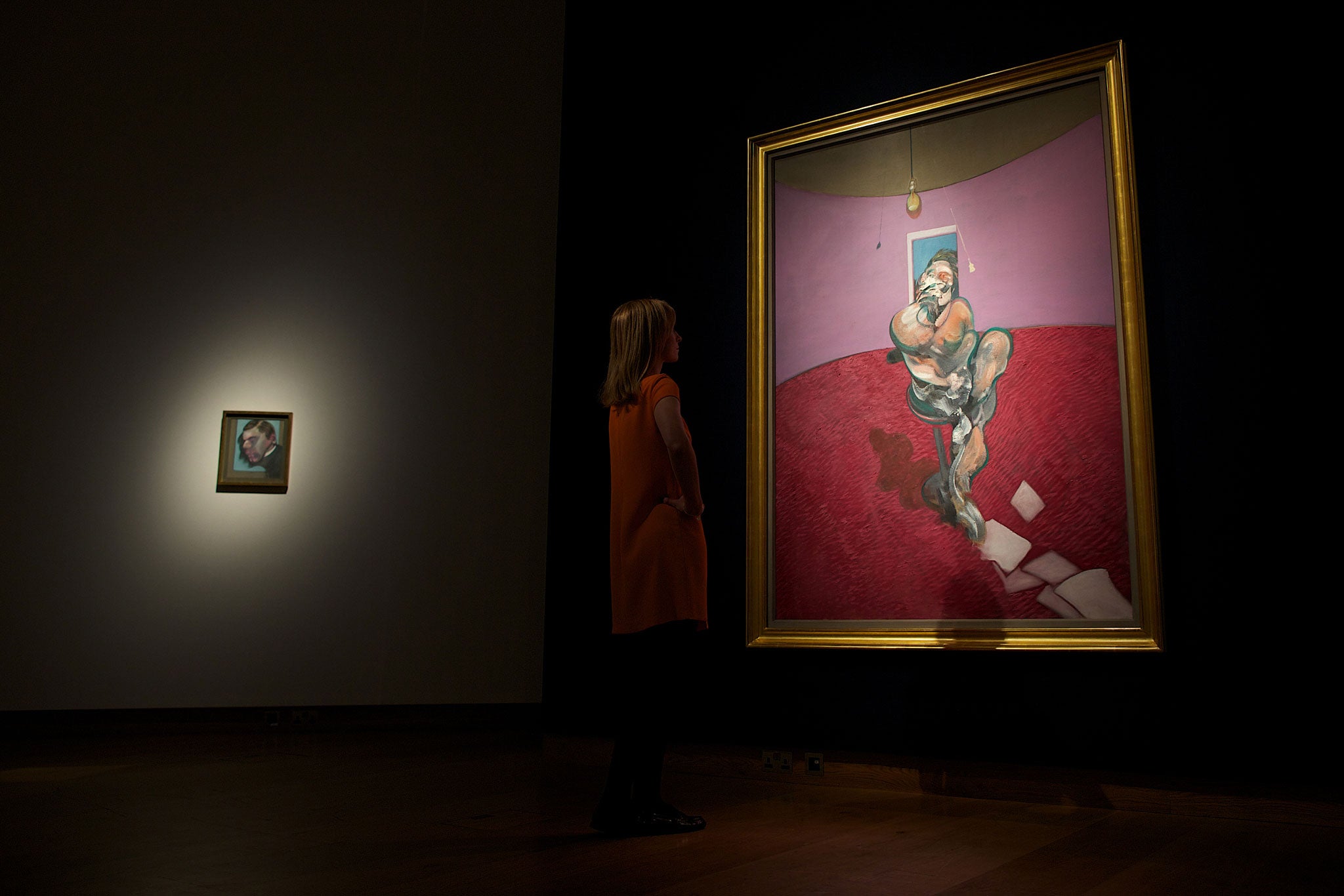 A Christie's employee looks at a work entitled 'Portrait of George Dyer Talking' by British artist Francis Bacon