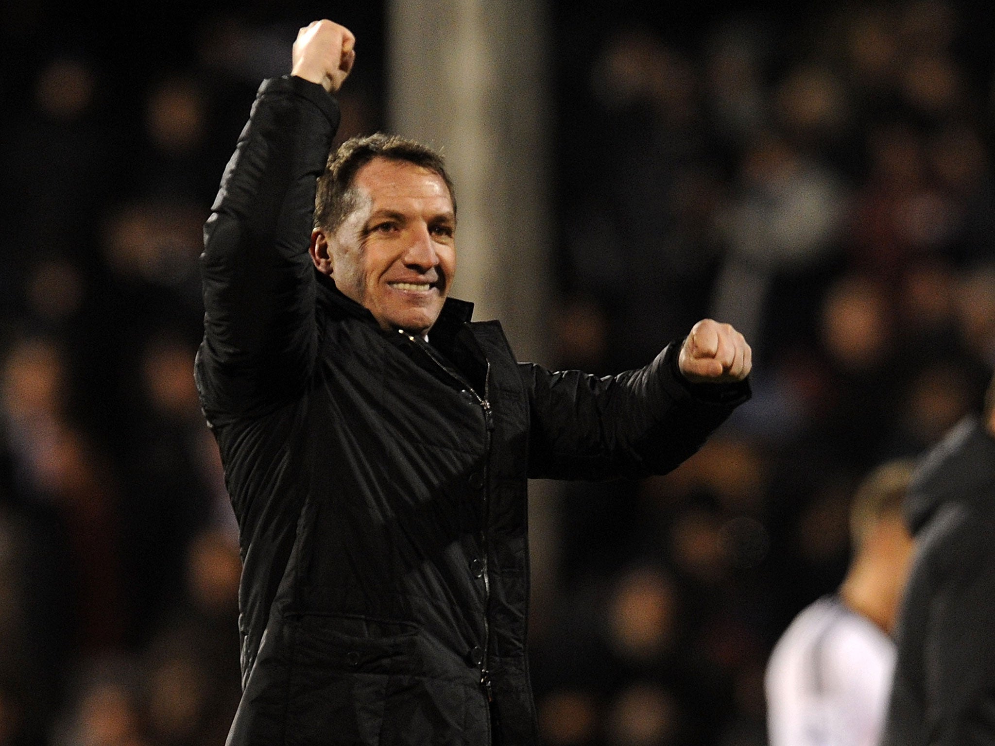 Brendan Rodgers celebrates the 3-2 victory over Fulham that put Liverpool back in with a chance of Premier League success