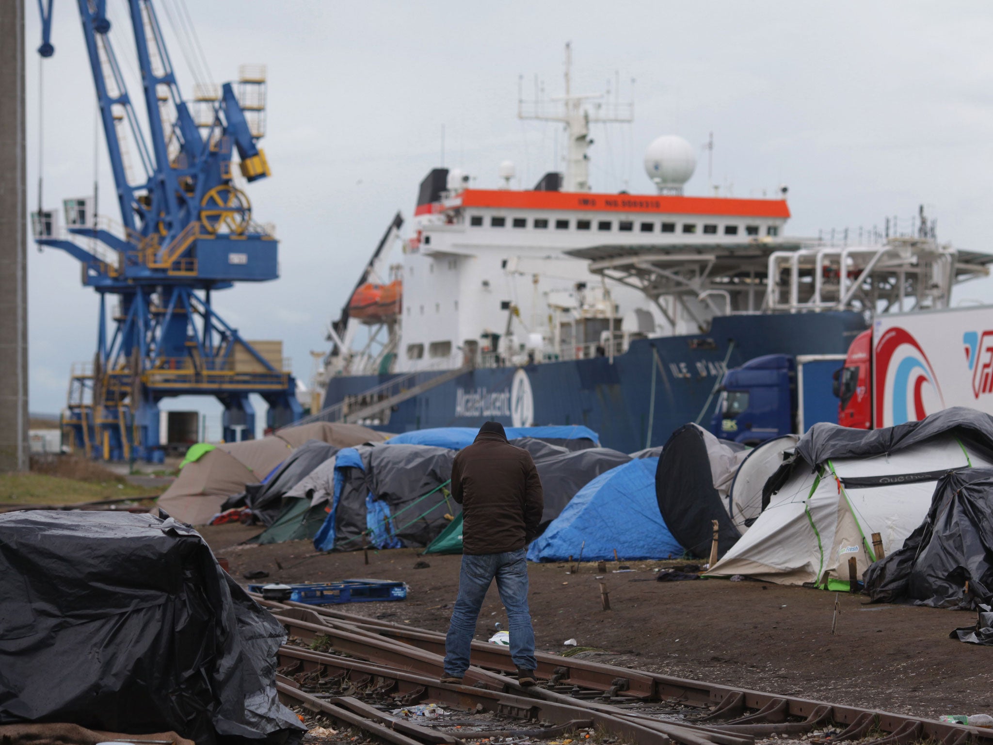 A man stands among the tents at the campsite just outside Calais, France (Justin Sutcliffe)