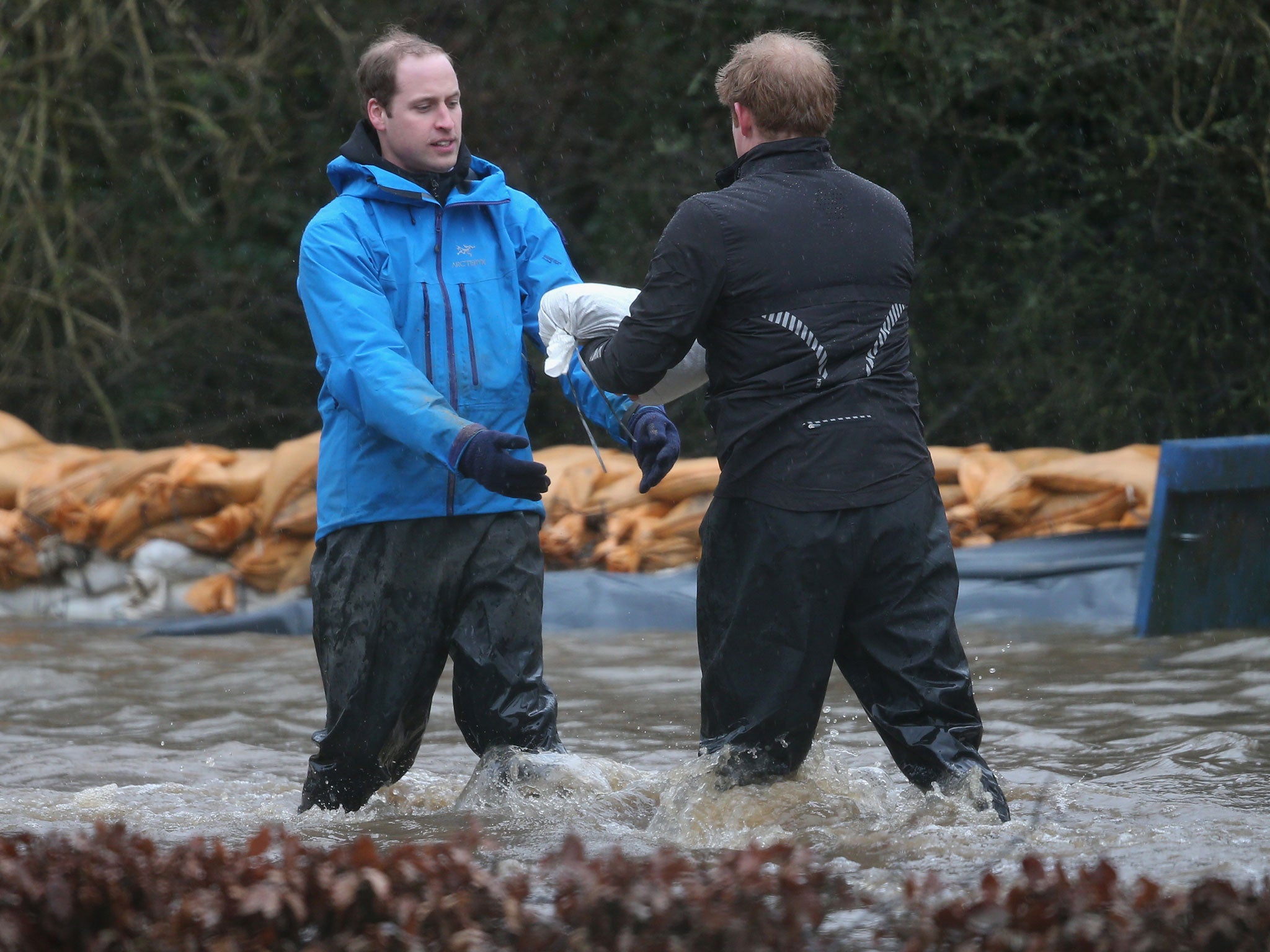 Prince William and Prince Harry help with flood defences around Eton End School in Datchet