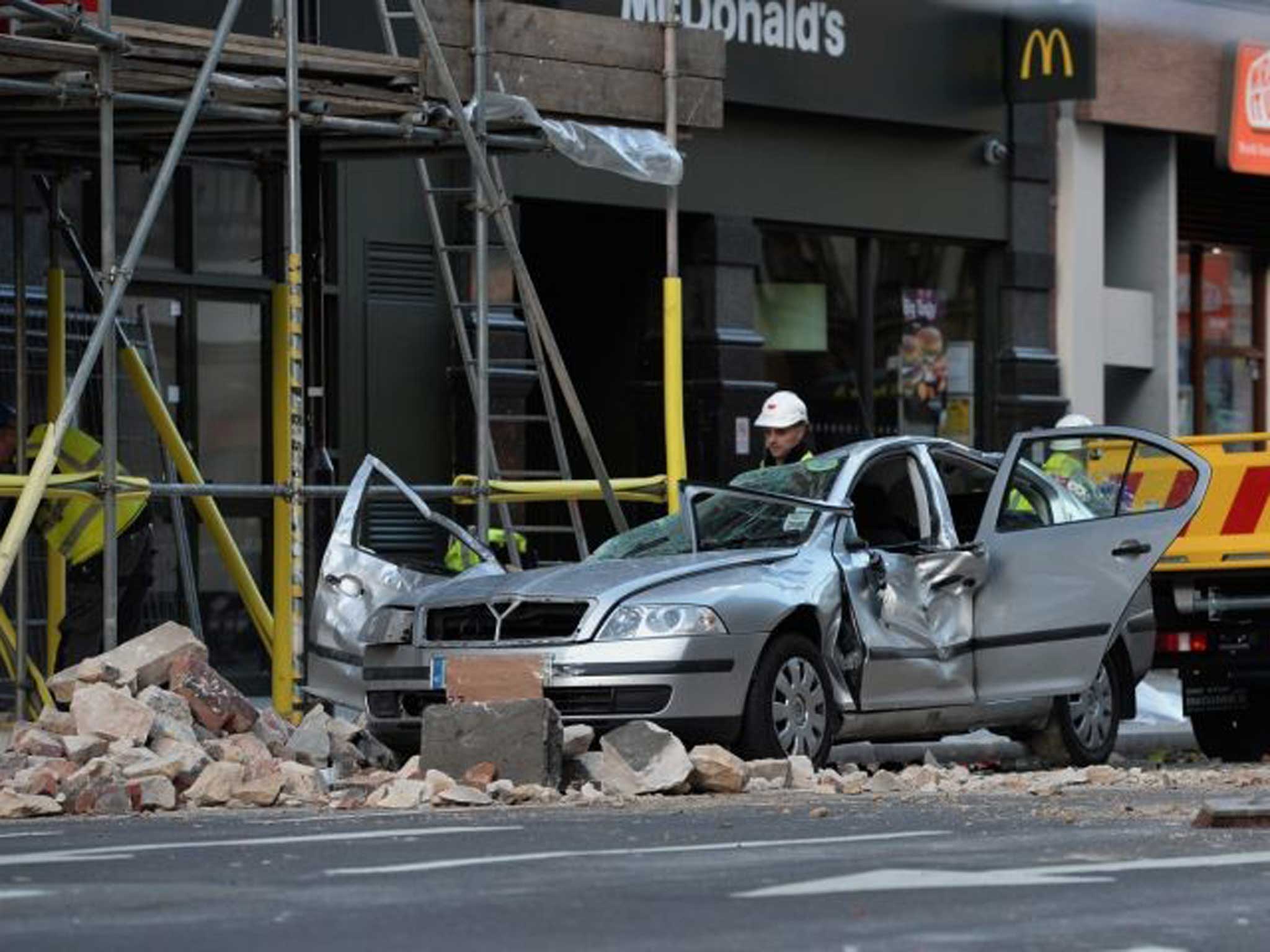Storm damage: Police clear fallen masonry from the car in central London