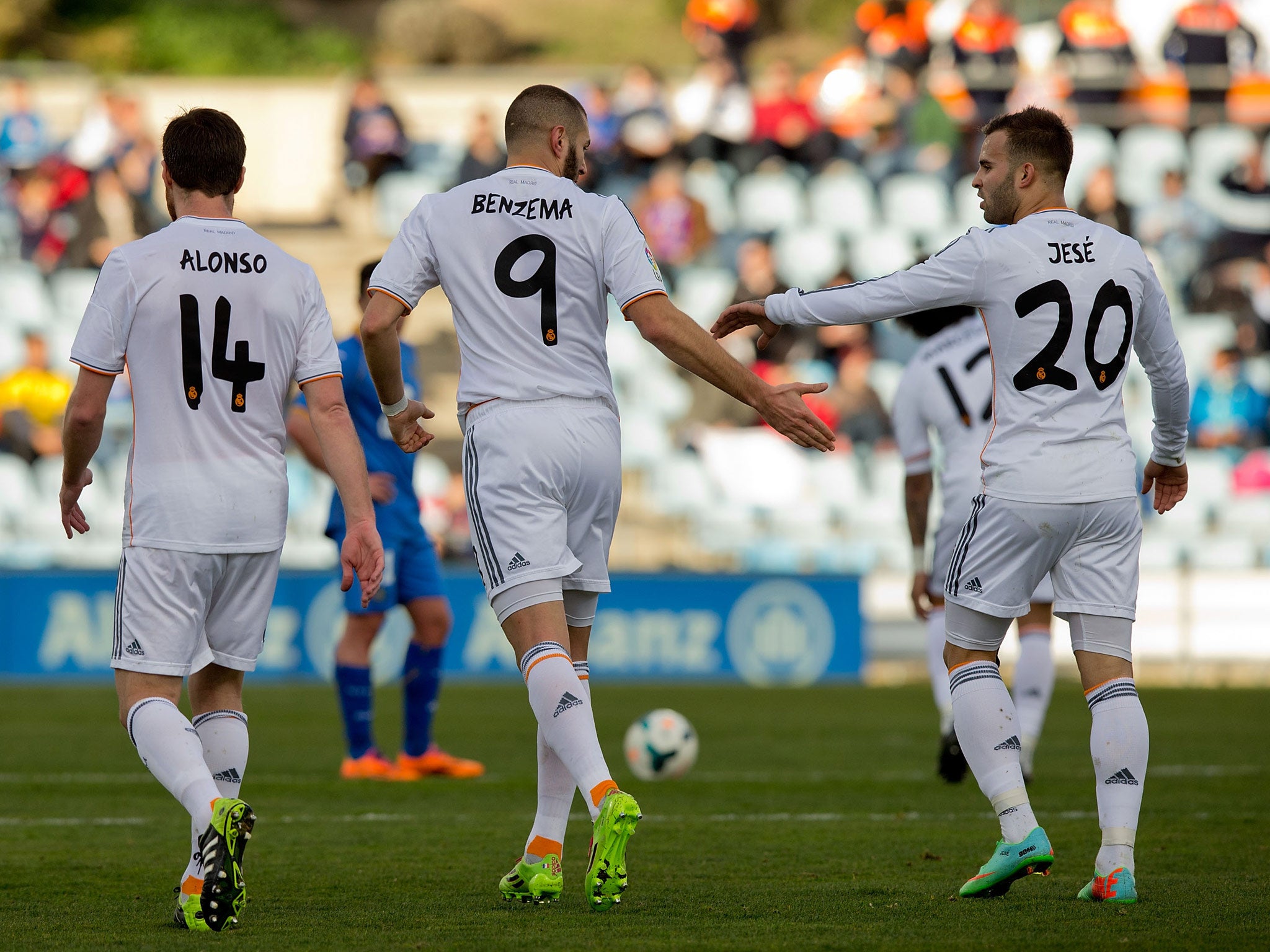 Karim Benzem of Real Madrid CF celebrates scoring their second goal against Getafe with teammate Jese Rodriguez in their 3-0 win