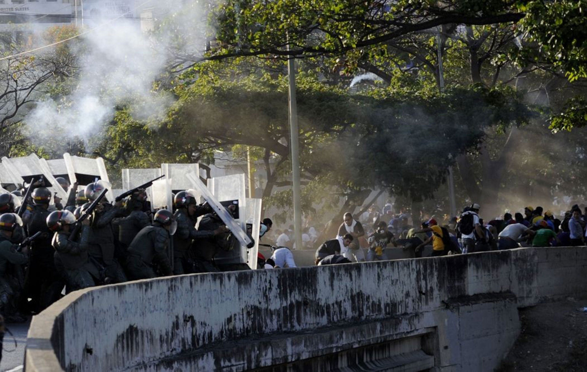 National Guard troops clash with anti-government students protesting in Caracas