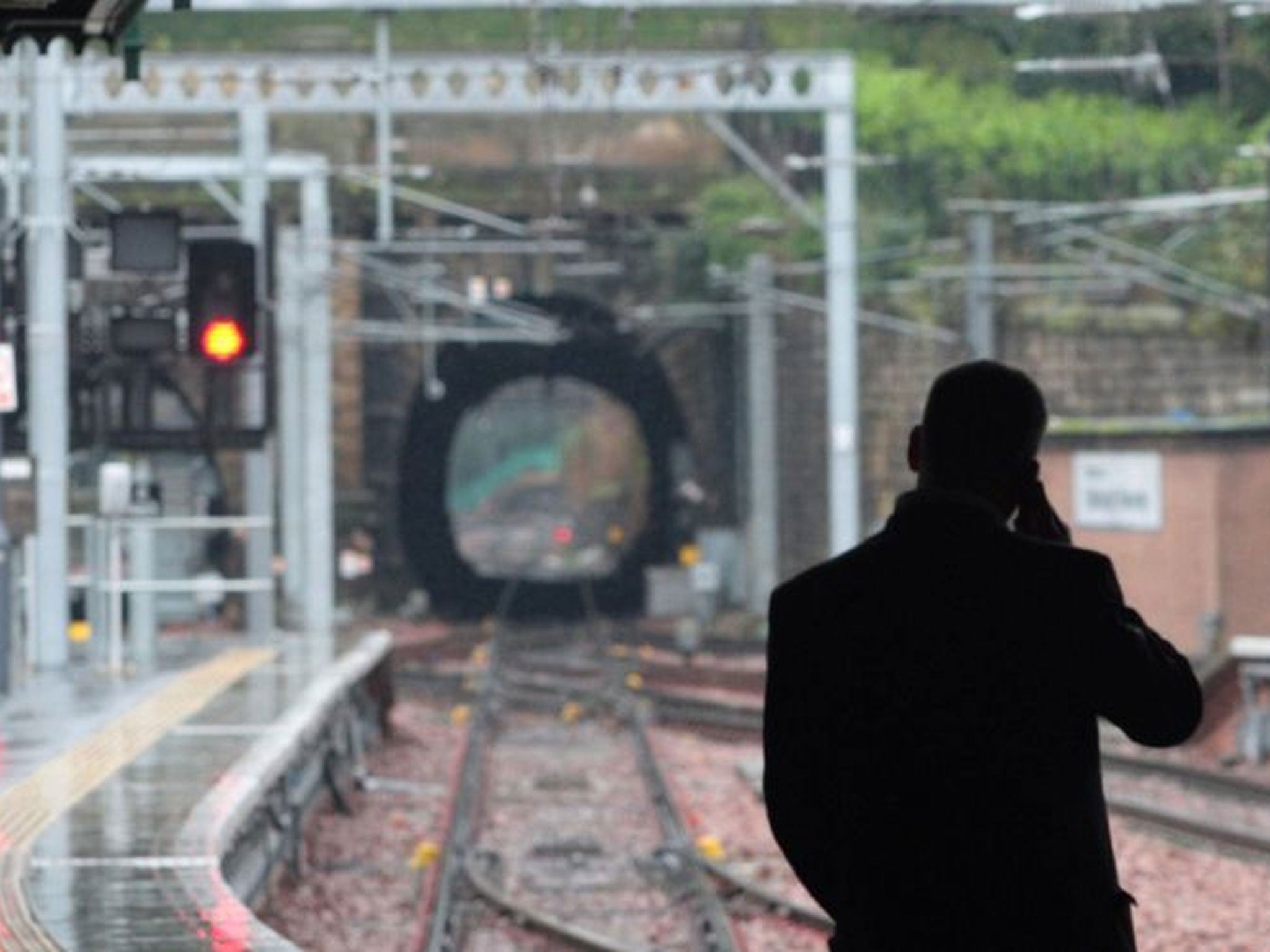 A man waiting at a train station as passenger satisfaction levels have dipped below 50% for the majority of train companies