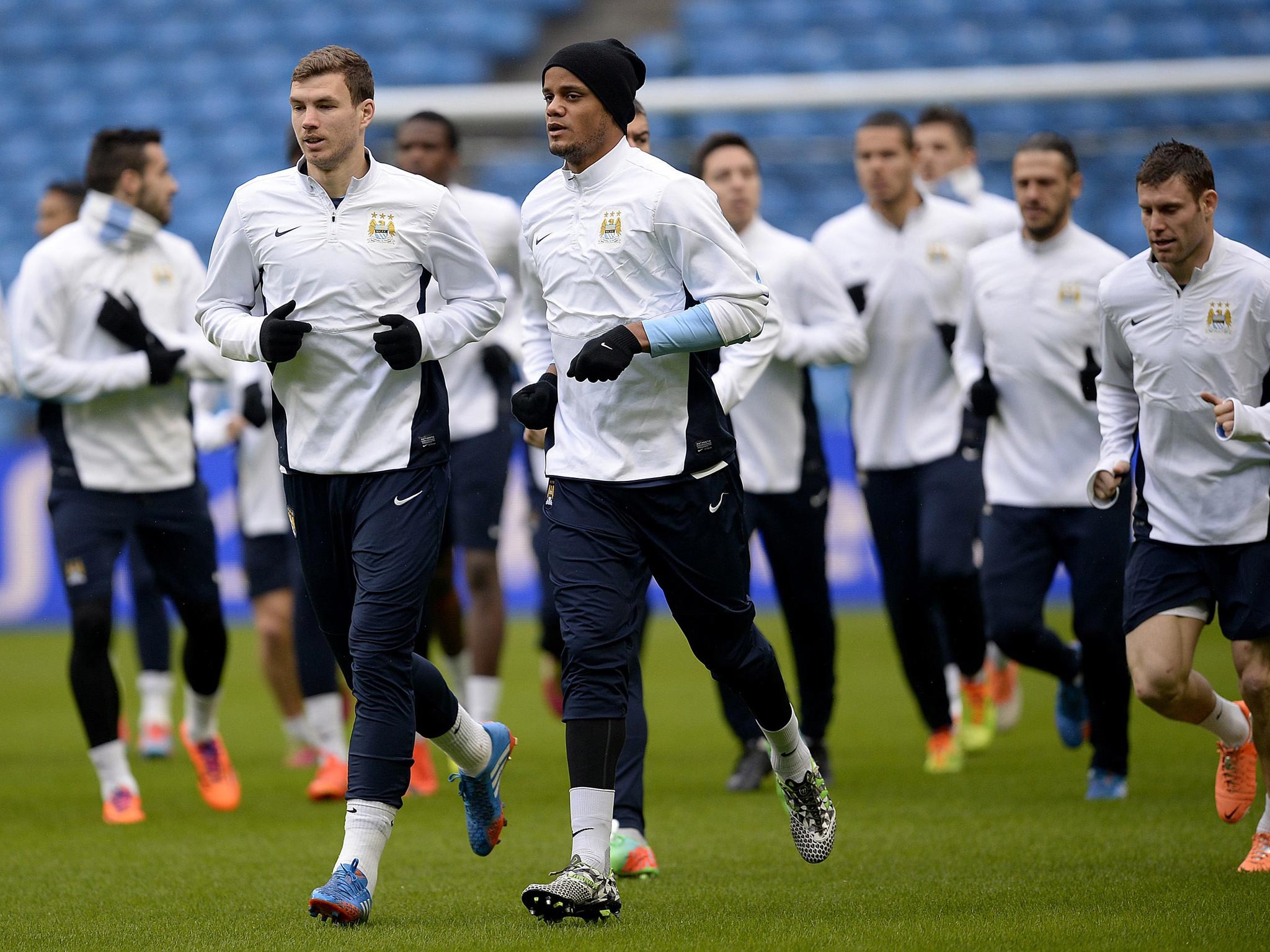 Edin Dzeko (left) and Vincent Kompany during a Manchester City training session at the Etihad yesterday