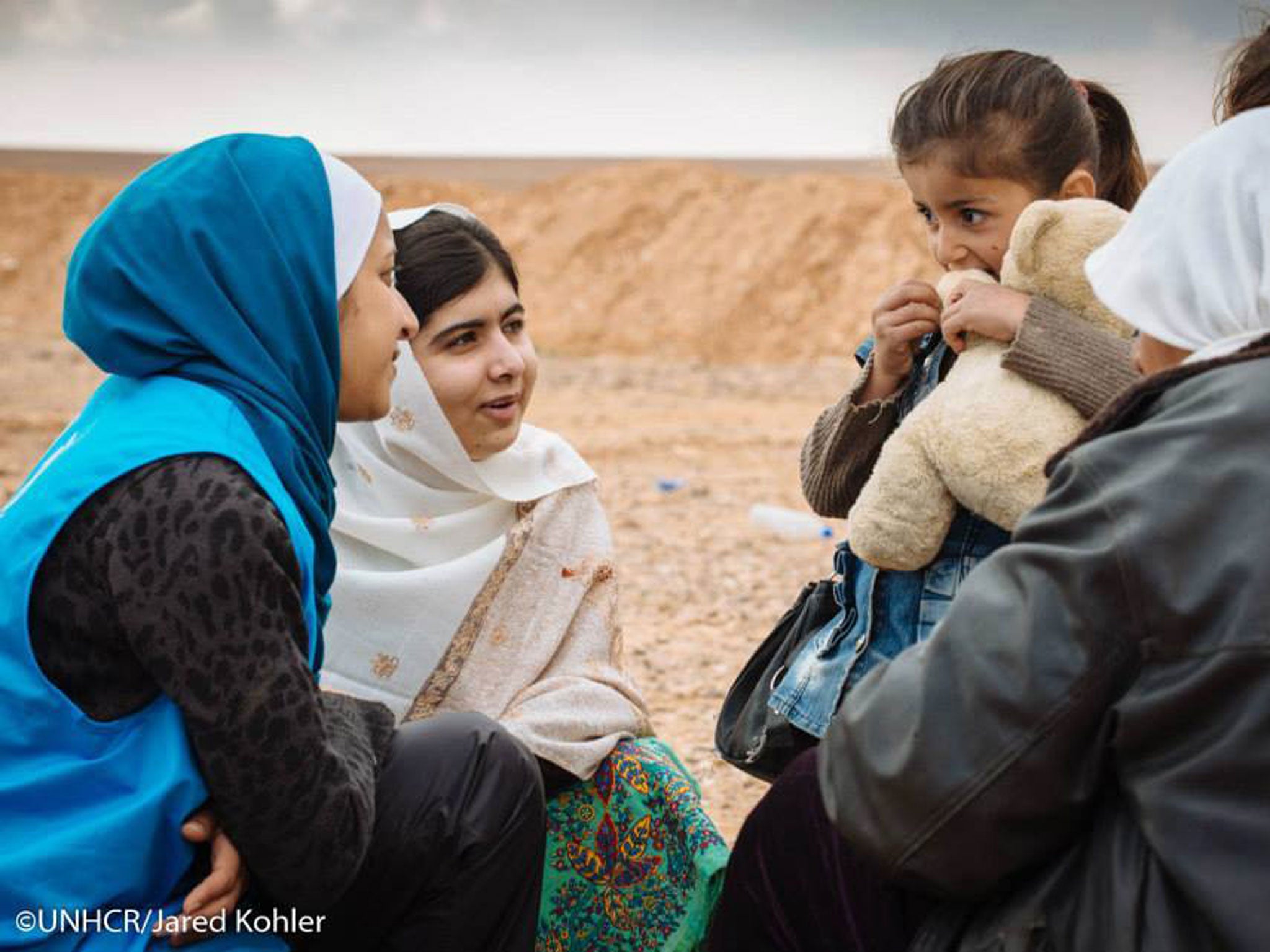 Malala Yousafzai (second from left) talks to a newly-arrived 5-year-old-girl and her family (UNHCR)