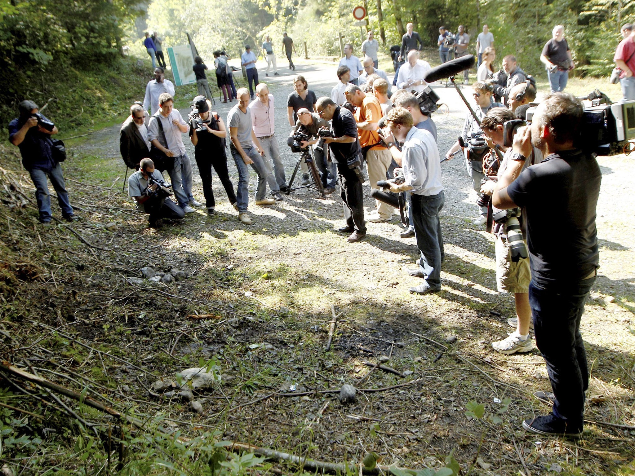 Media gather at the site of the killings in Chevaline