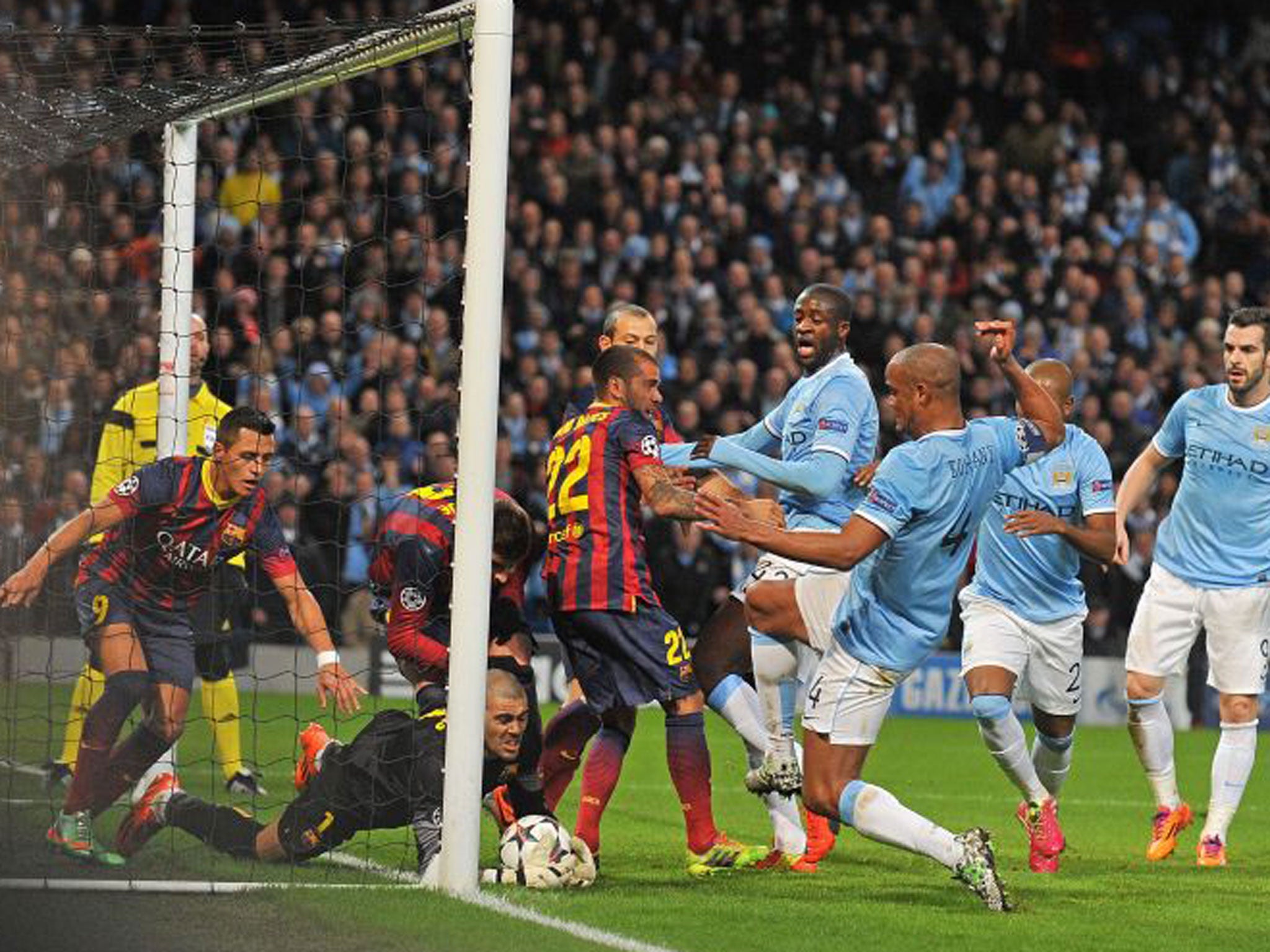 Barcelona's goalkeeper Victor Valdes makes a save near his line after initially missing the cross