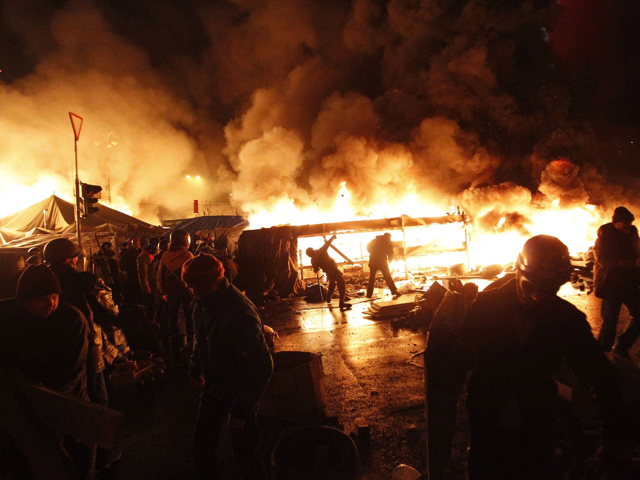 Anti-government protesters throw missiles during clashes with riot police at the Independence Square in Kiev