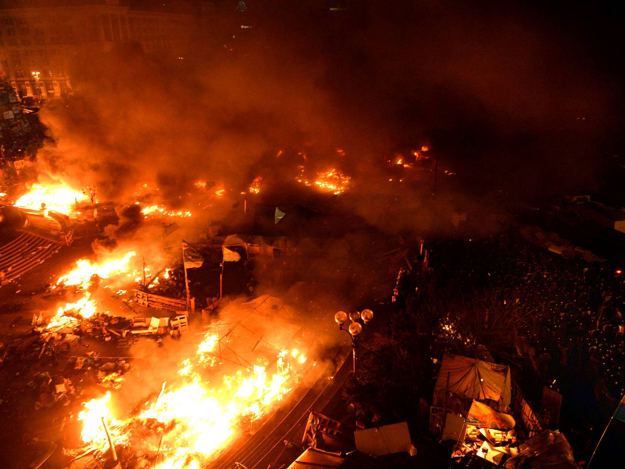 Anti-government protesters clash with the police during their storming of Independence Square in Kiev