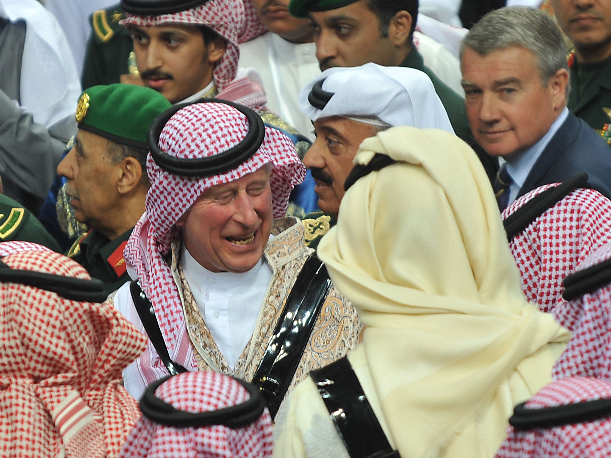 Prince Charles talks with unidentified Saudi Emirs after the end of the traditional Saudi dancing