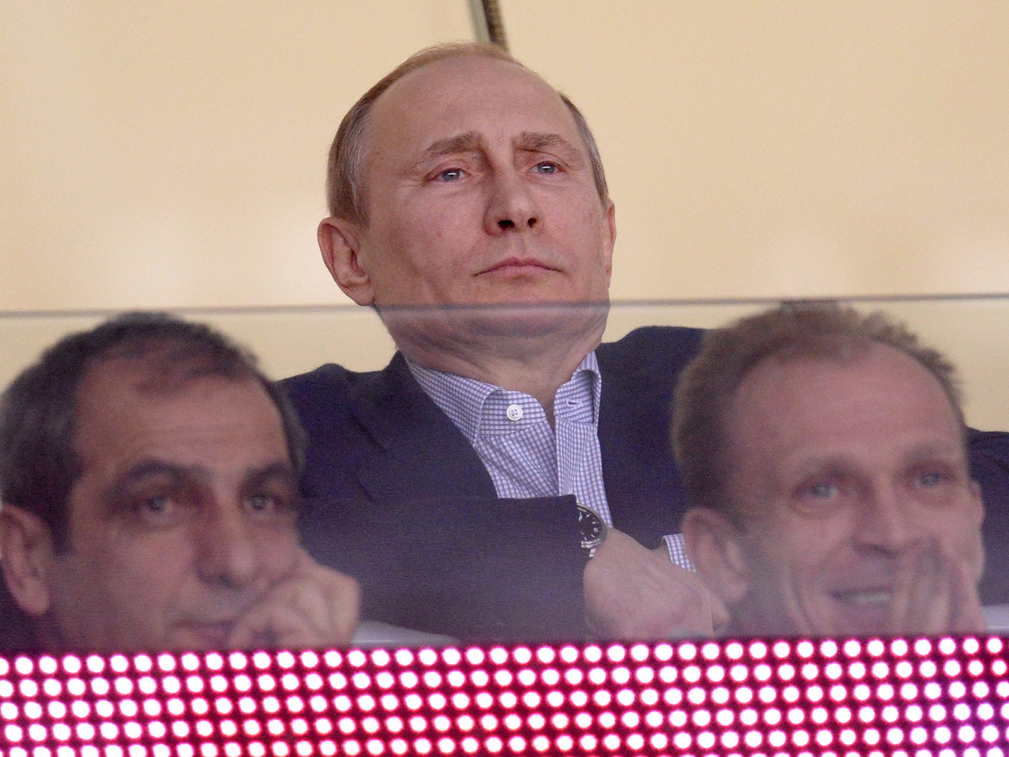 Vladimir Putin looks on during the ice hockey