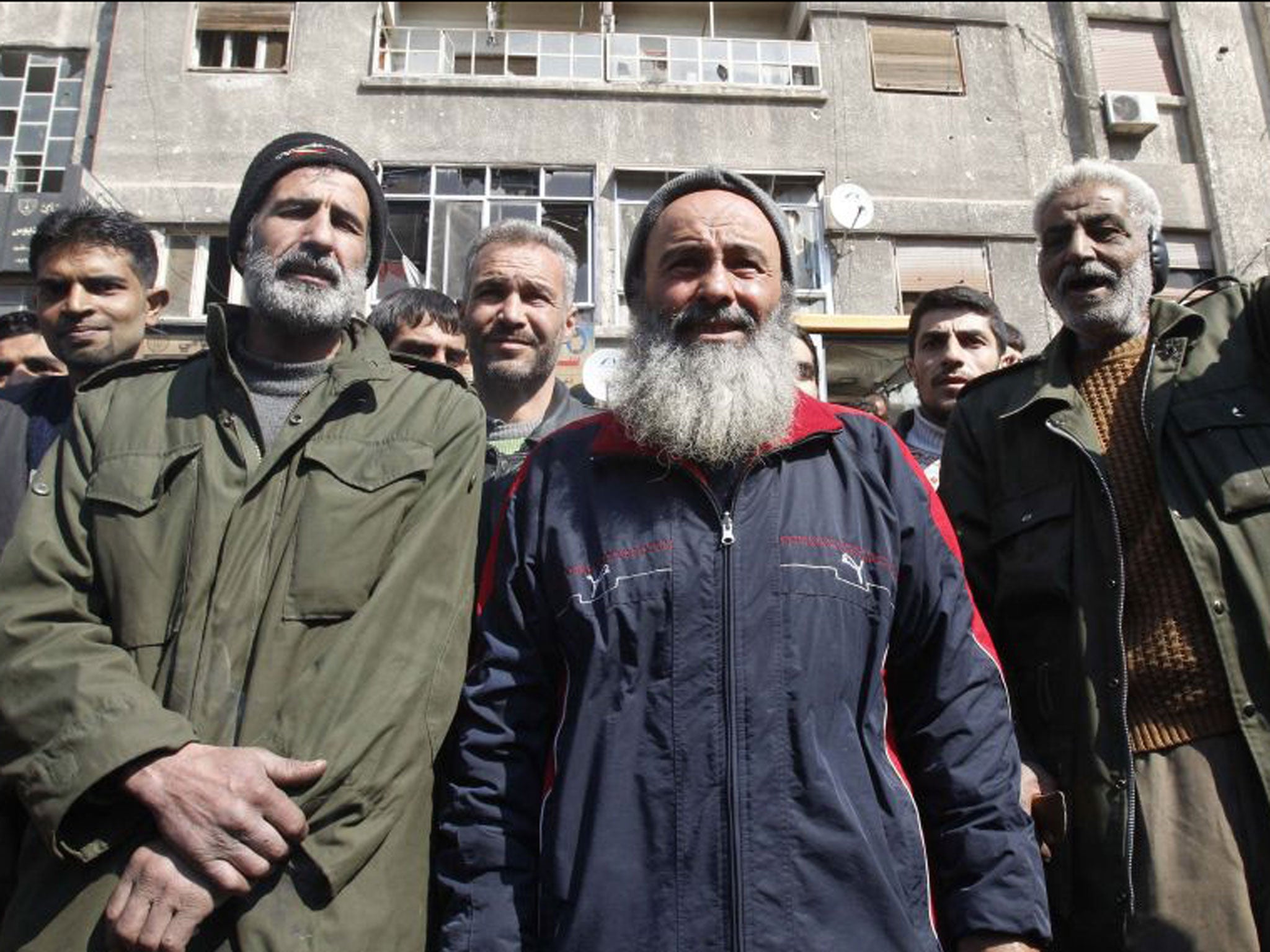 Syrian men shout slogans calling for Syrian unity in the town of Babbila