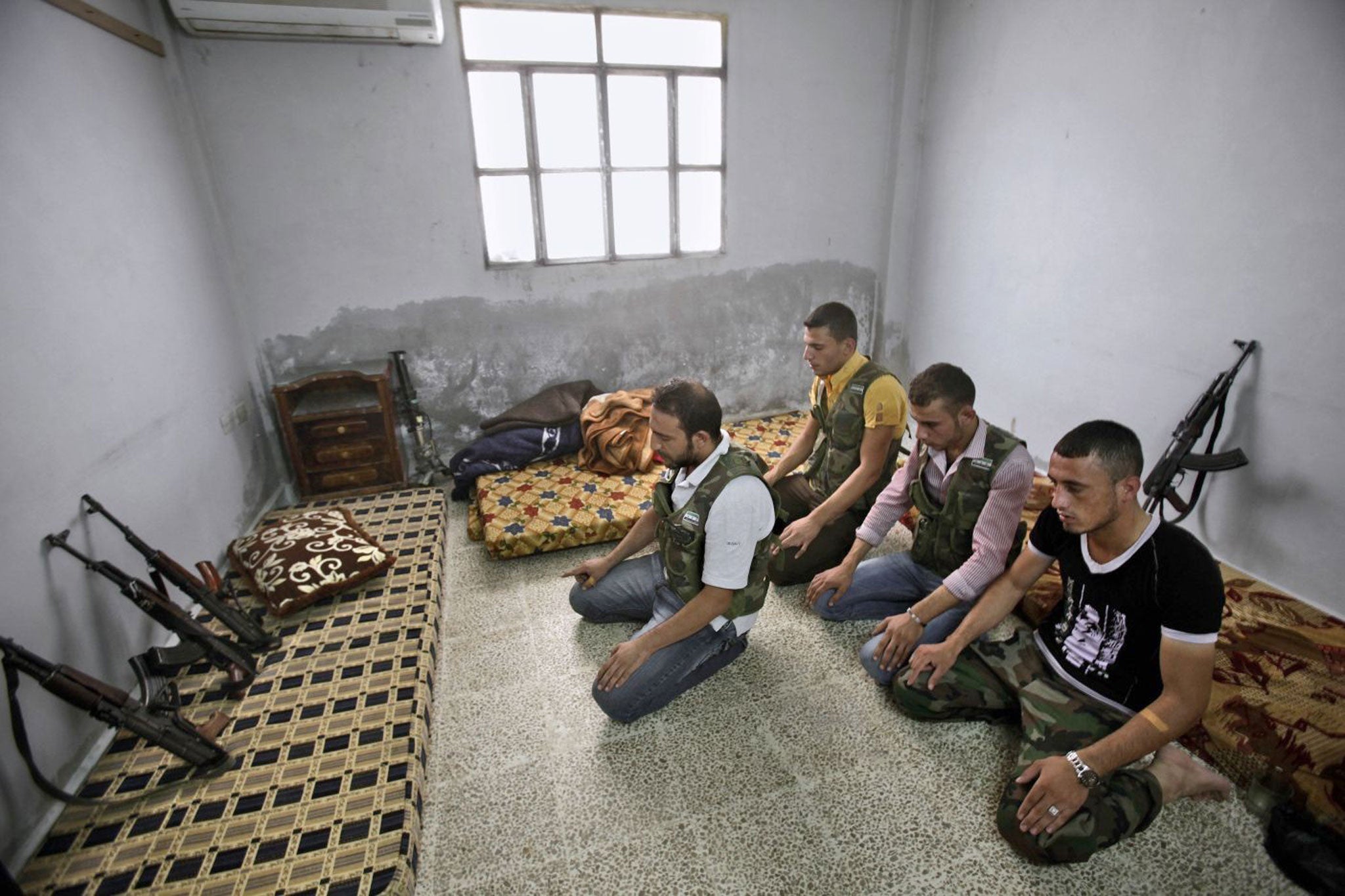 Sunni warriors: Syrian rebel fighters attend noon prayers before heading out to fight in Aleppo