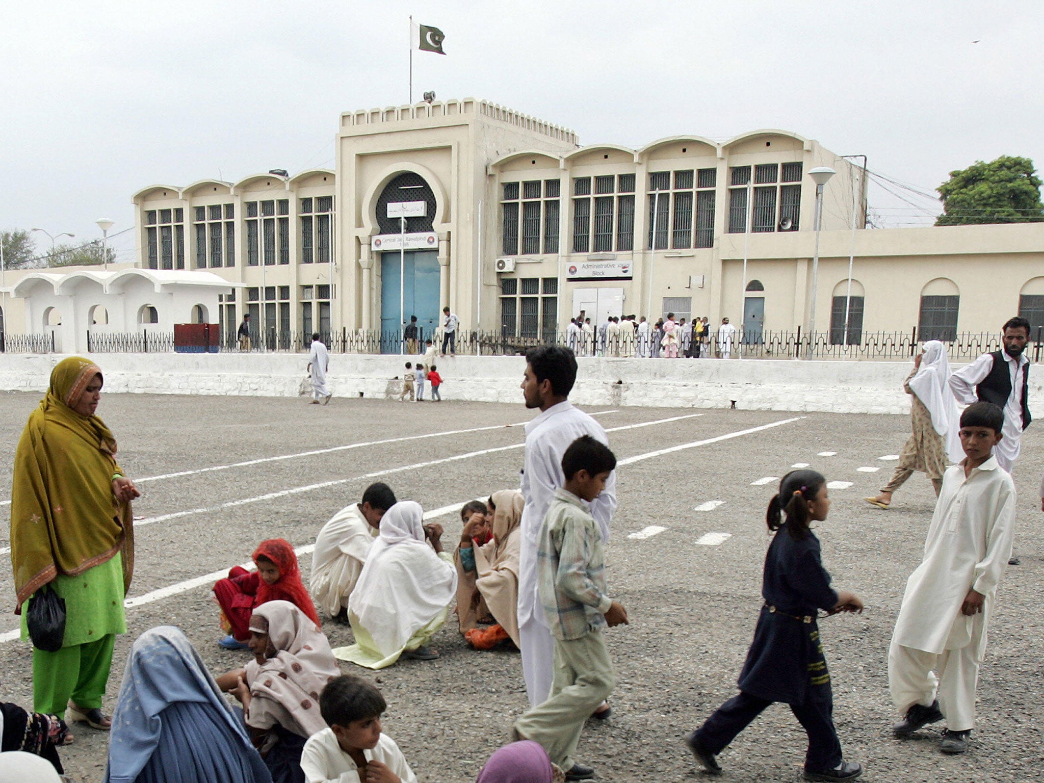 Pakistani visitors who come to see their jailed loved ones wait in the premises of Adiala Jail in Rawalpindi