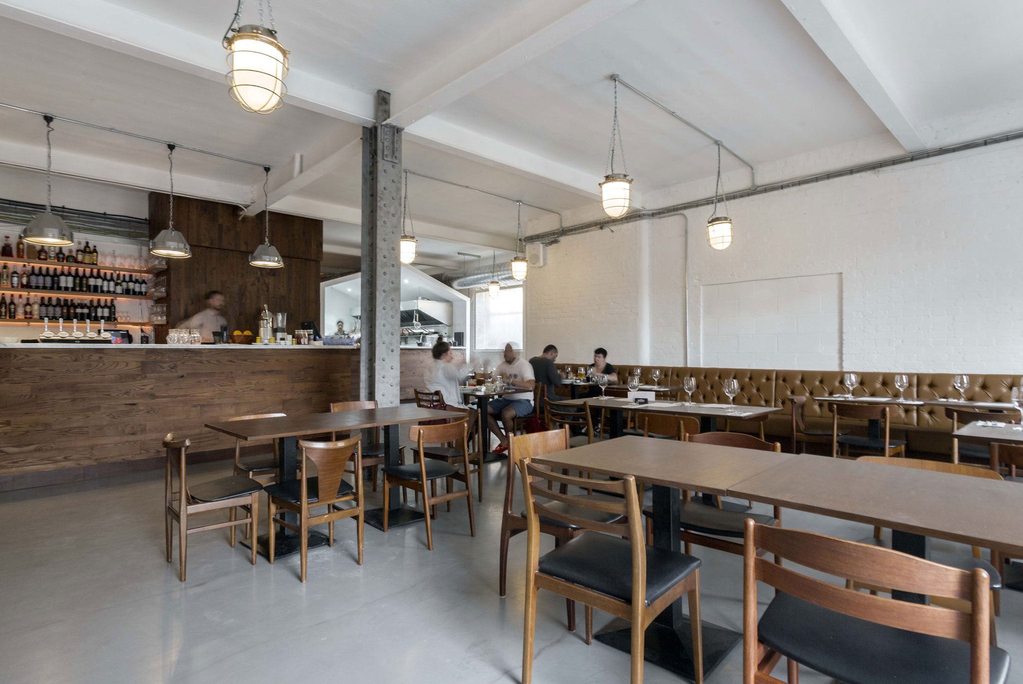 The restaurant's plain tables could be props from a Stratford East production of Les Miserables