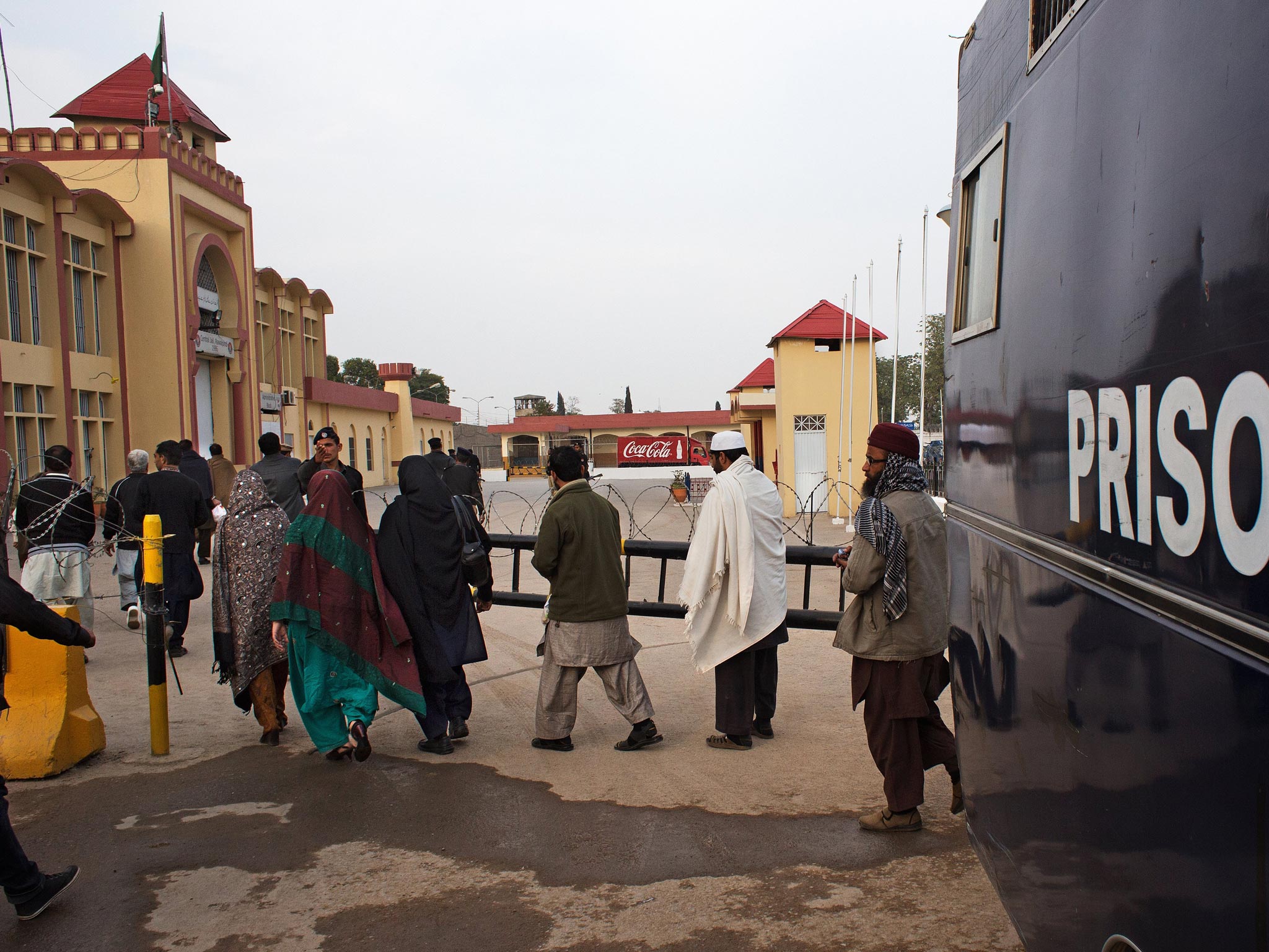 Prisoners are transferred from a prison van to the Rawalpindi central jail on their way back from the court house in Rawalpindi, Pakistan