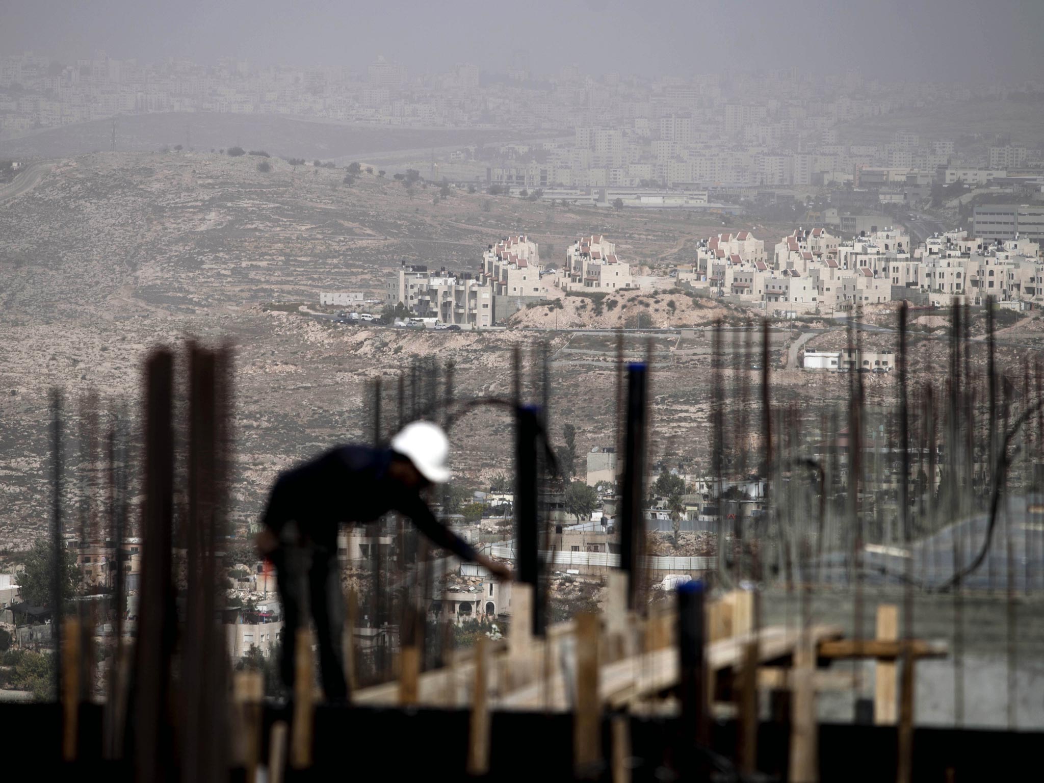 A Palestinian construction worker at a building site in the Jewish settlement of Ramt Shlomo, near the Arab neighborhood of Beit Hanina, East Jerusalem