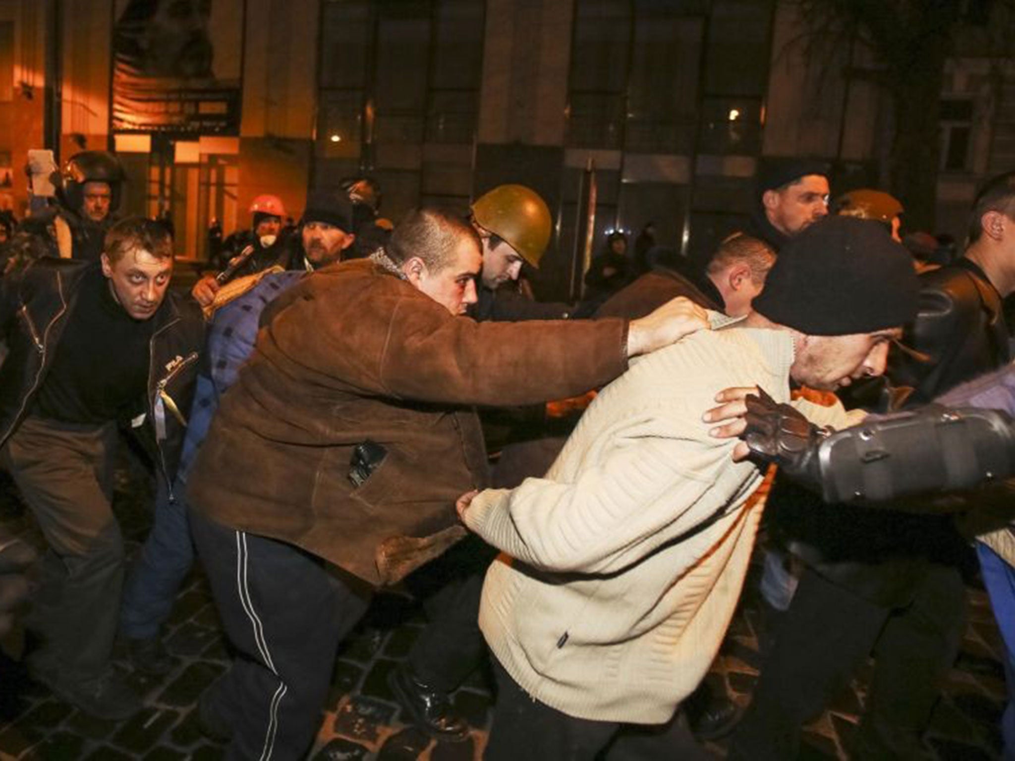 Interior Ministry members in plain-clothes are escorted out of Independence Square