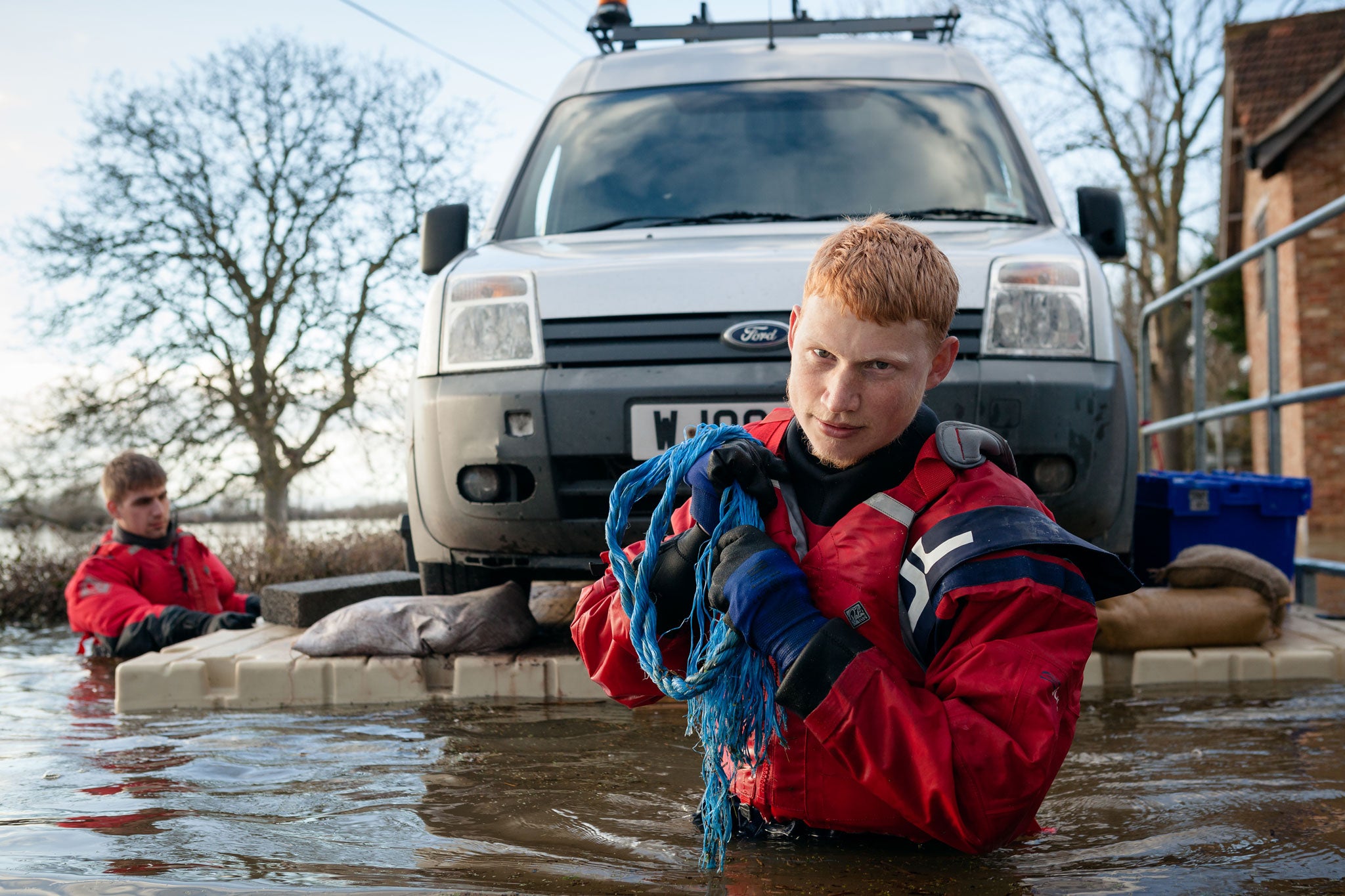 FLAG volunteers Aaron and Jay transport a trapped Environment Agency van over the flood waters on a floating pontoon