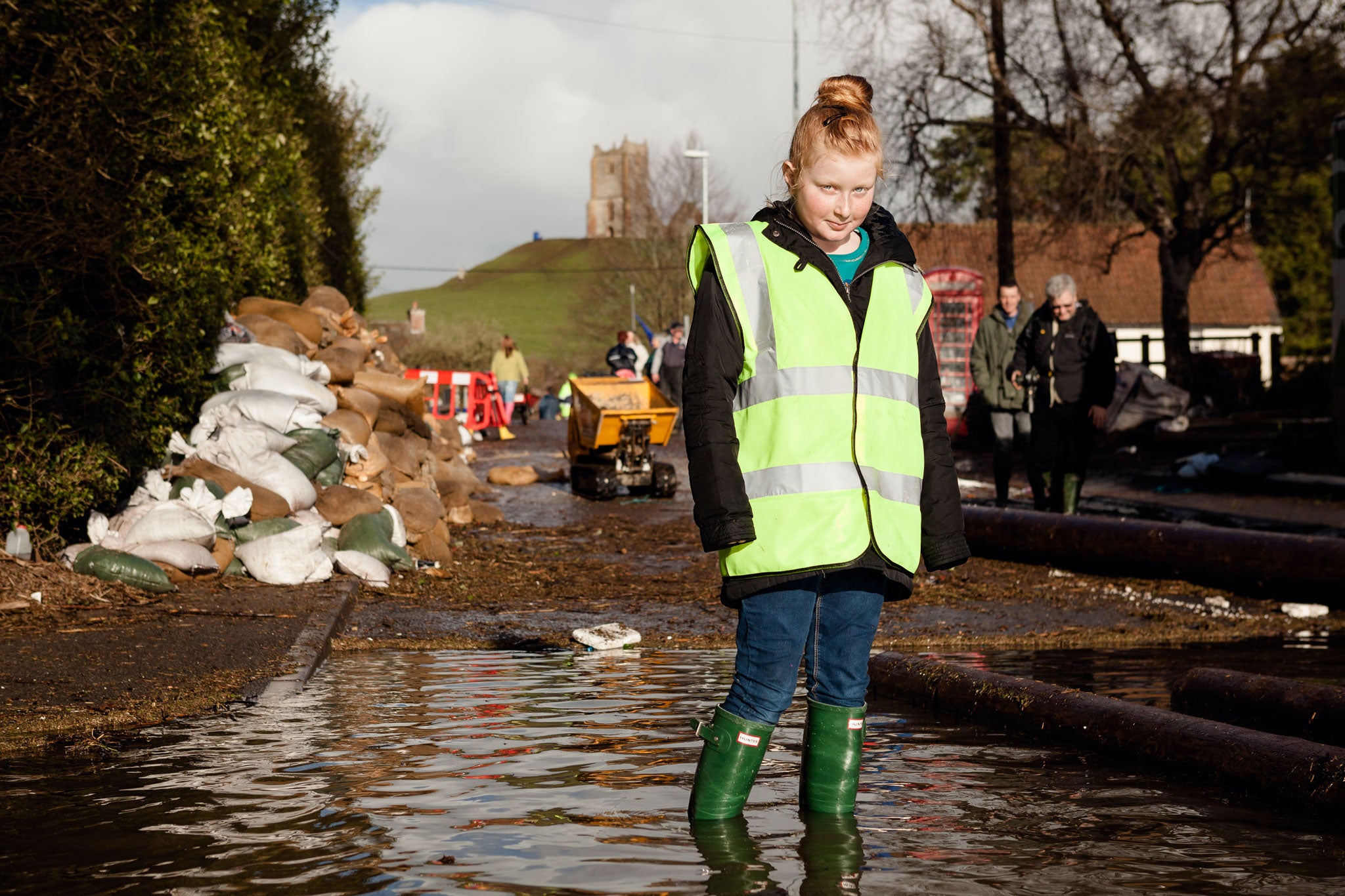 Local volunteer Clare shovels wood-chip to help strengthen the riverbanks