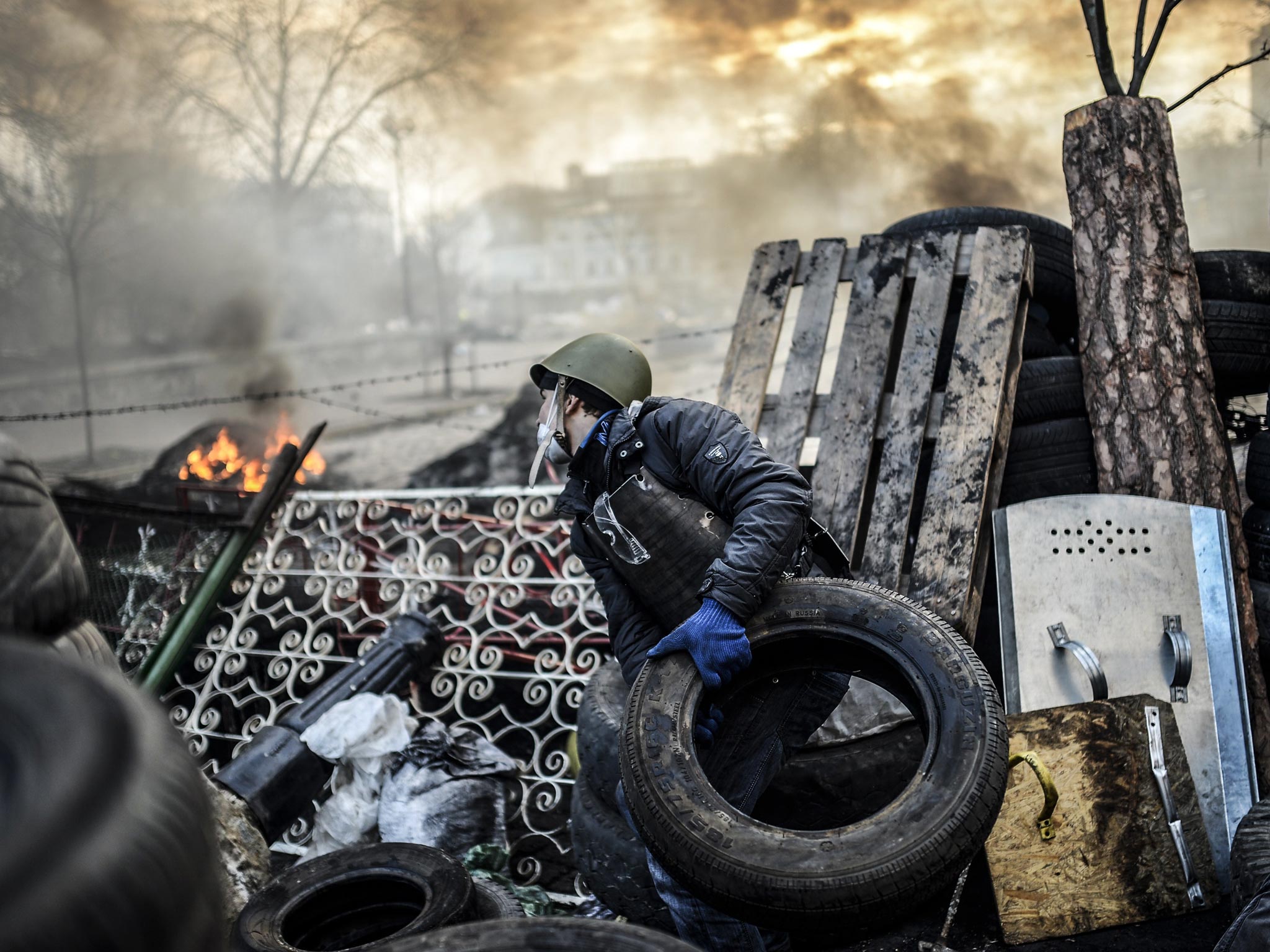 A protester manning a barricade in Kiev yesterday