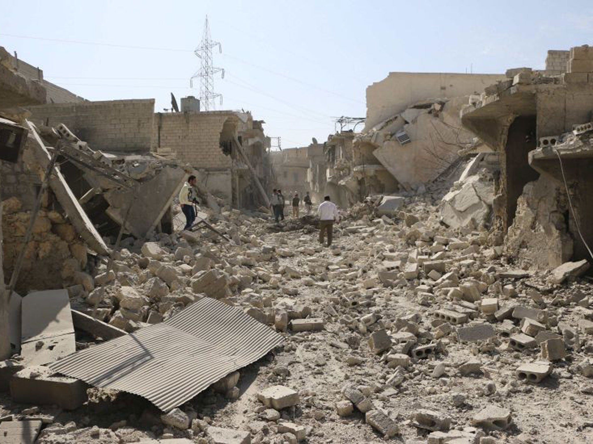 Aleppo residents look for survivors amid damage and debris after what activists said were explosive barrels thrown by forces loyal to President Assad