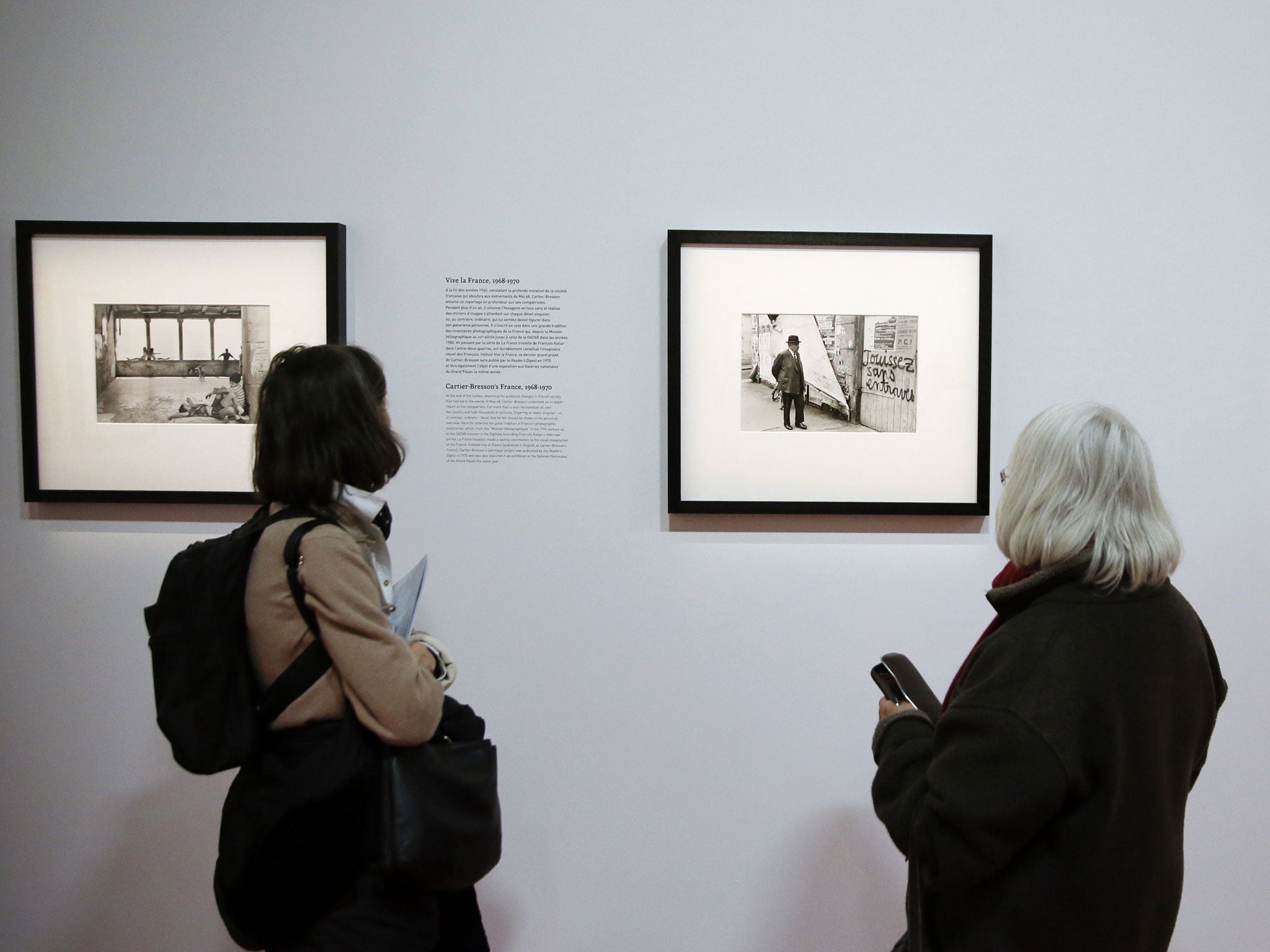 People look at Cartier-Bresson's pictures at the retrospective