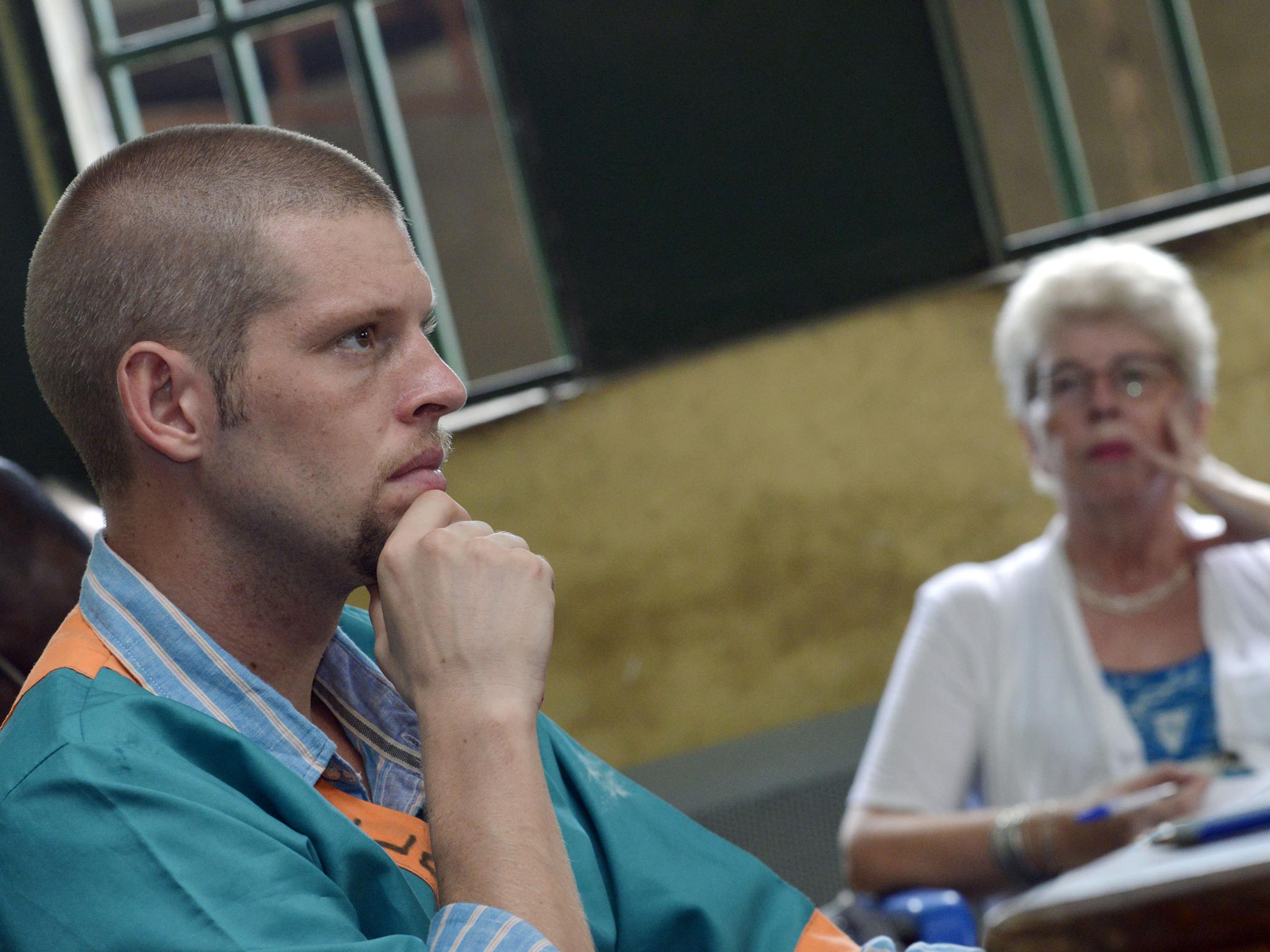 Joshua French listens to testmony during his trial in Ndolo military prison in Kinshasa, watched by his mother, Kari Hilde French