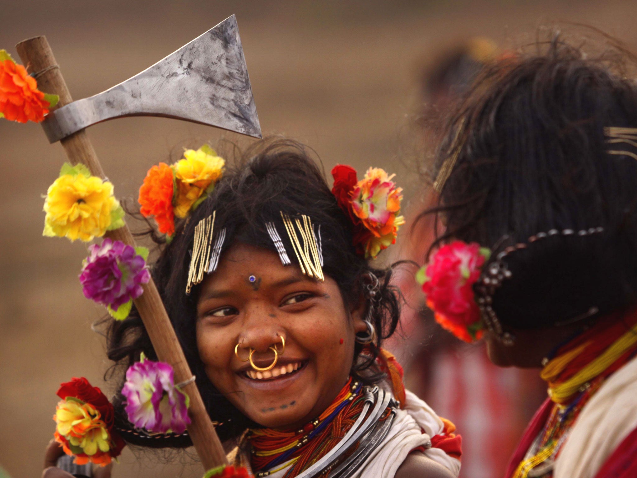 A Dongria tribe girl holds her traditional weapon and dance on the last day of their two days long Niyamraja Festival atop of the Niyamgiri hills near Lanjigarh in Kalahandi district, Orissa state