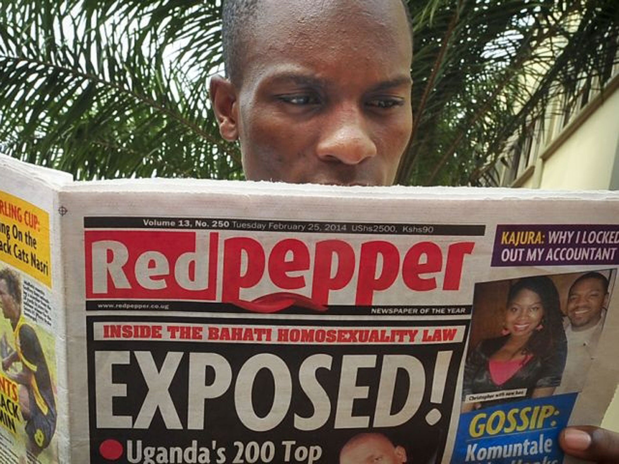 A Ugandan reads a copy of the "Red Pepper" tabloid newspaper.