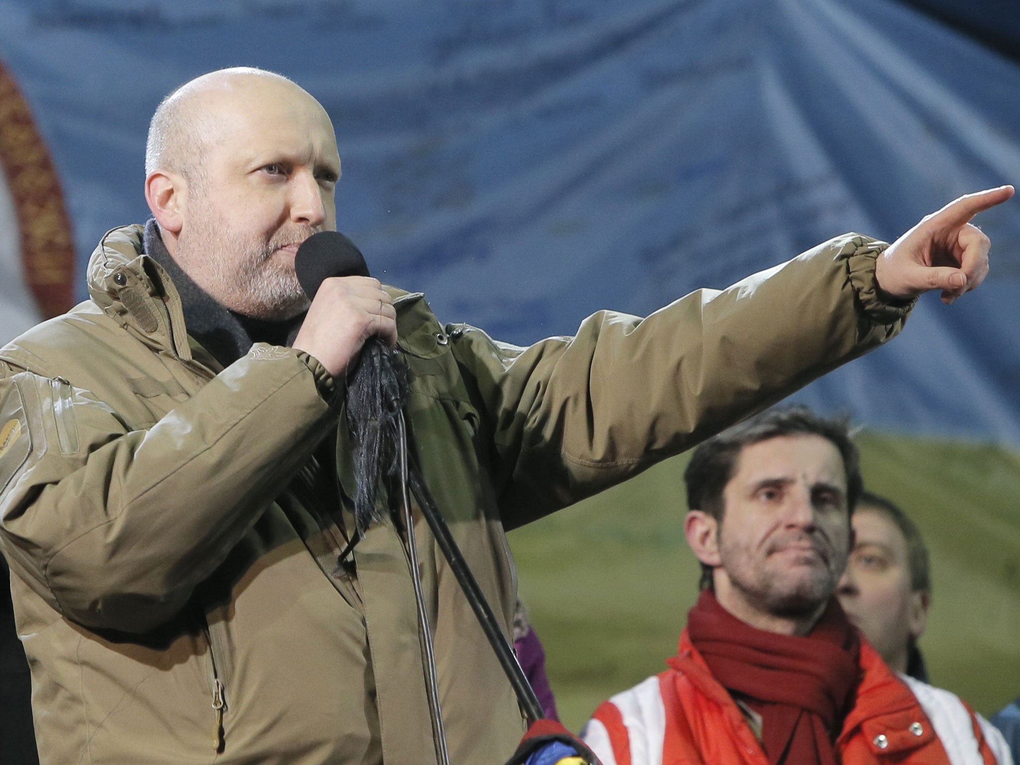 Ukraine's parliament speaker Oleksandr Turchynov represents candidates of the new Prime Minister and the Cabinet to people for approval in Kiev's Independence Square