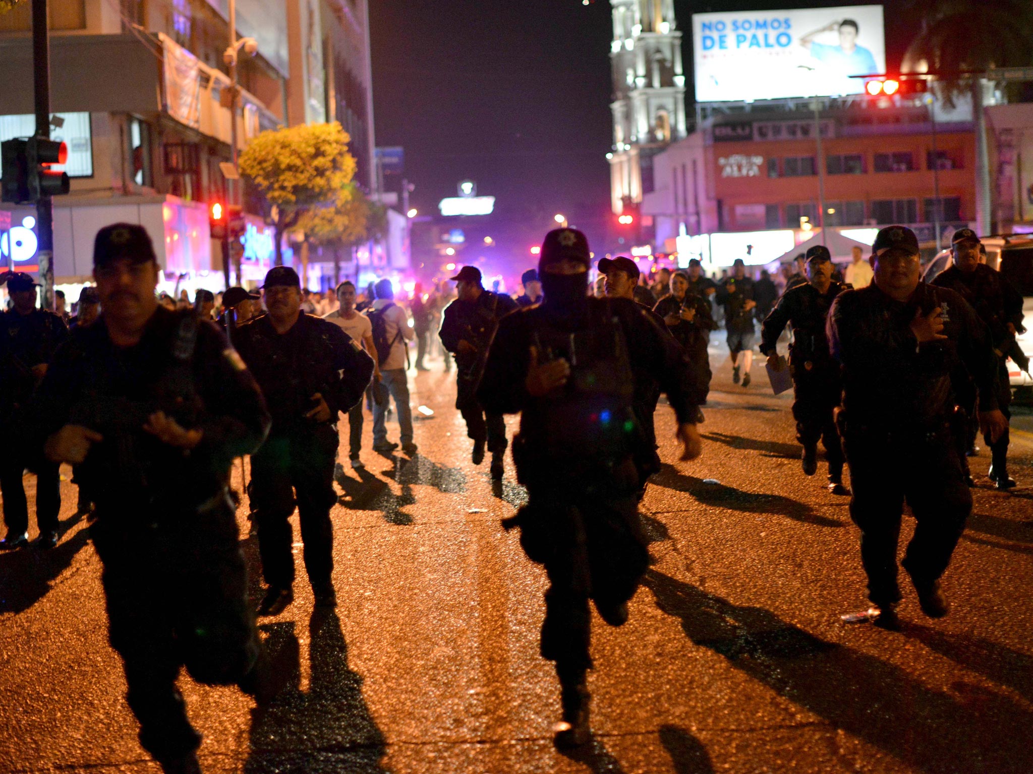 Police run to break up a protest in support of Mexican drug kingpin Joaquin Guzman Loera, aka "el Chapo Guzman" in Culiacan, Sinaloa State, Mexico