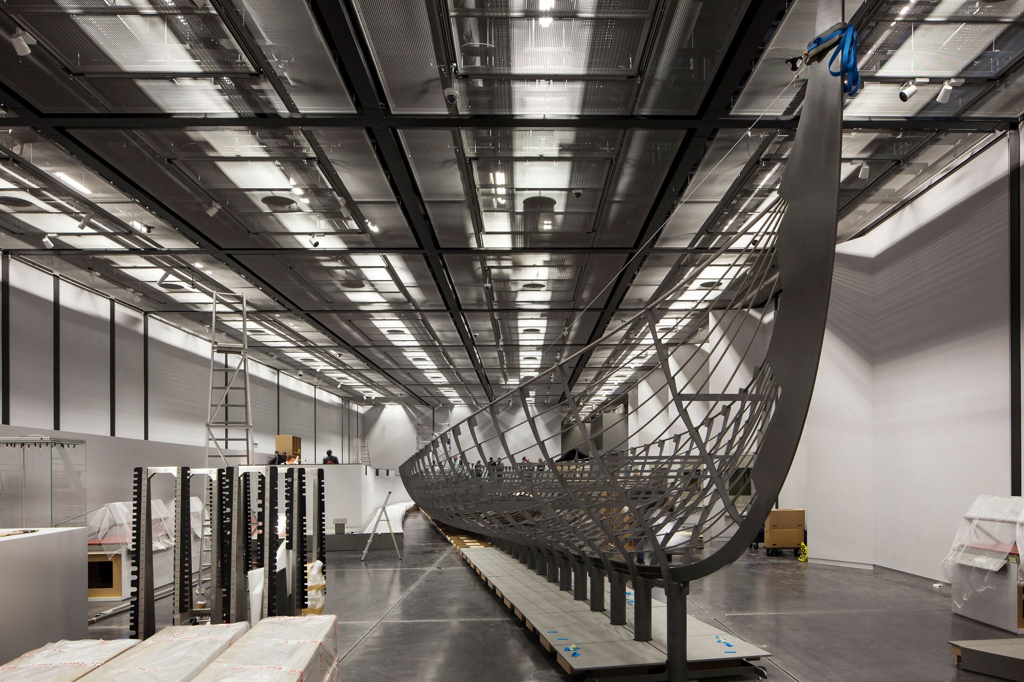 'Roskilde 6' being installed at the British Museum. The keel measures 32m long, and it has been estimated that there would have been about 78 oarsmen powering the boat along