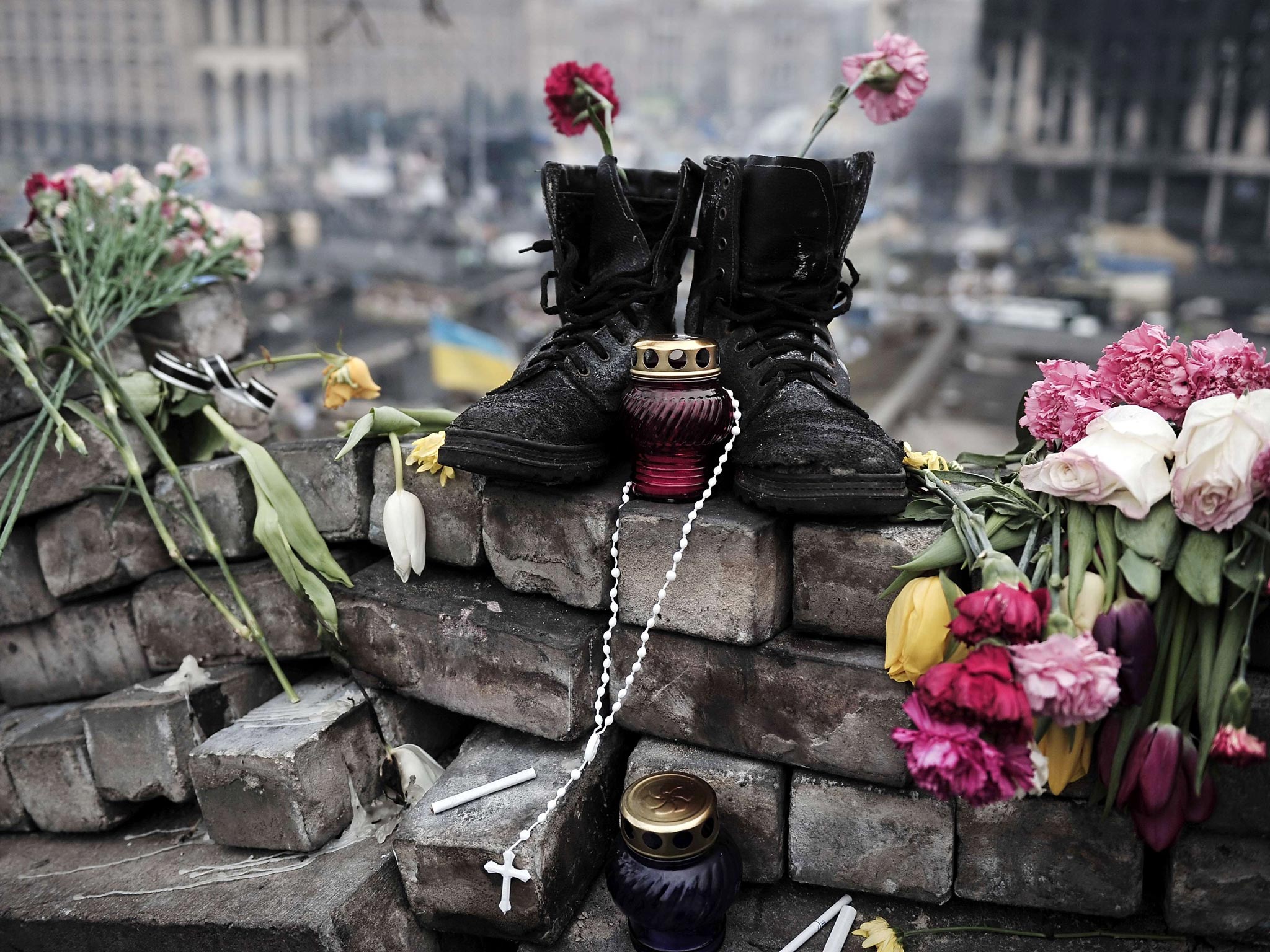 Boots belonging to a protester are left on a makeshift memorial at the Independence square in central Kiev